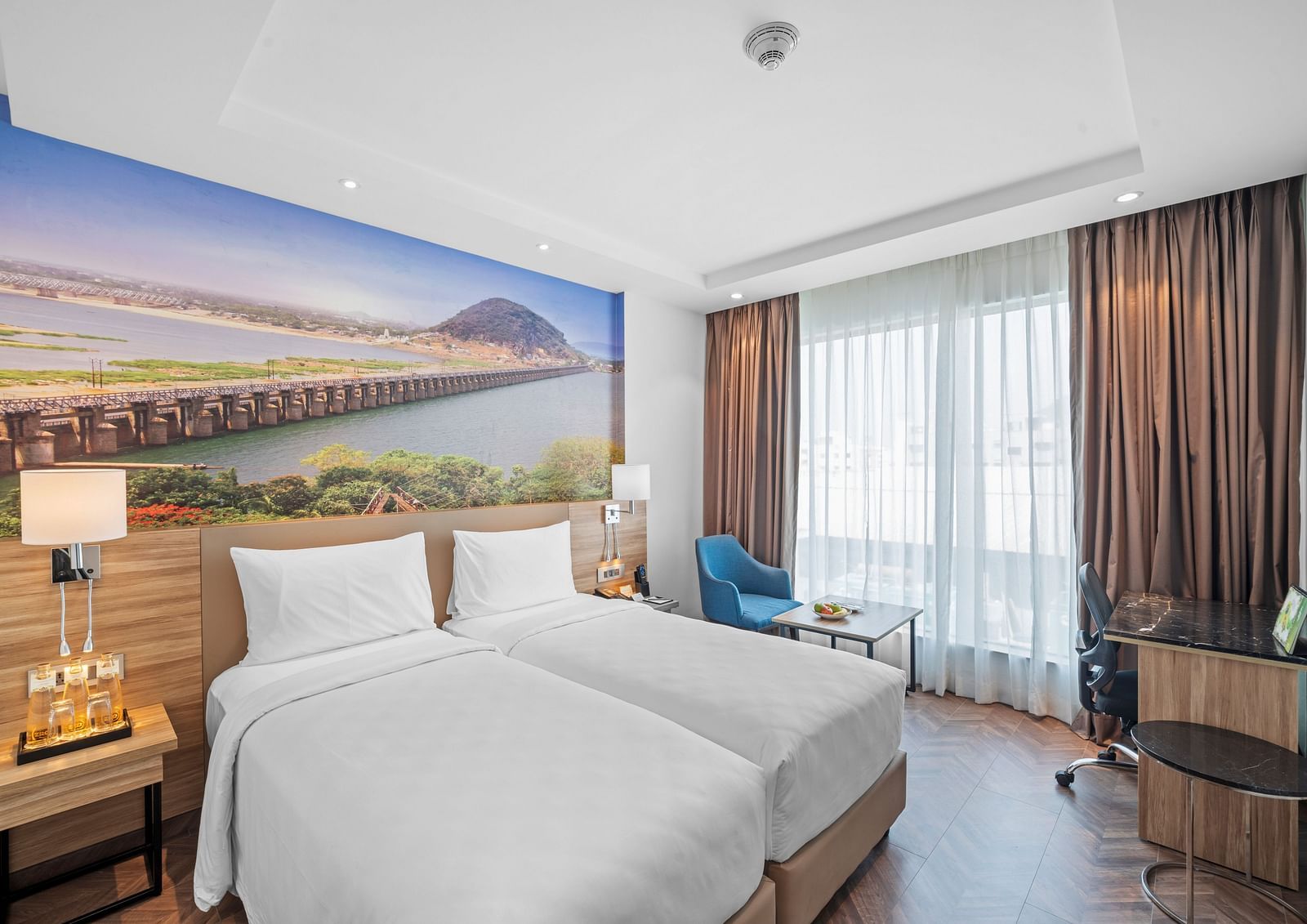A room featuring two twin beds at Grand Vijayawada by GRT Hotels near Kanaka Durga Temple, Vijayawada.