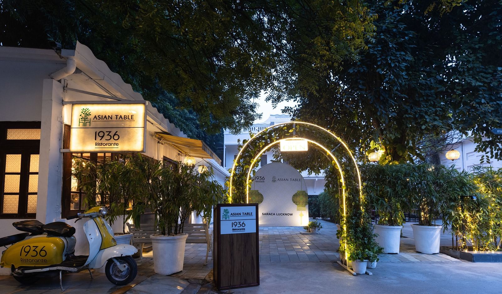 Entrance to 1936 Ristorante and Asian Table restaurants at Saraca Hotel, Lucknow with a lot of greenery surrounding it