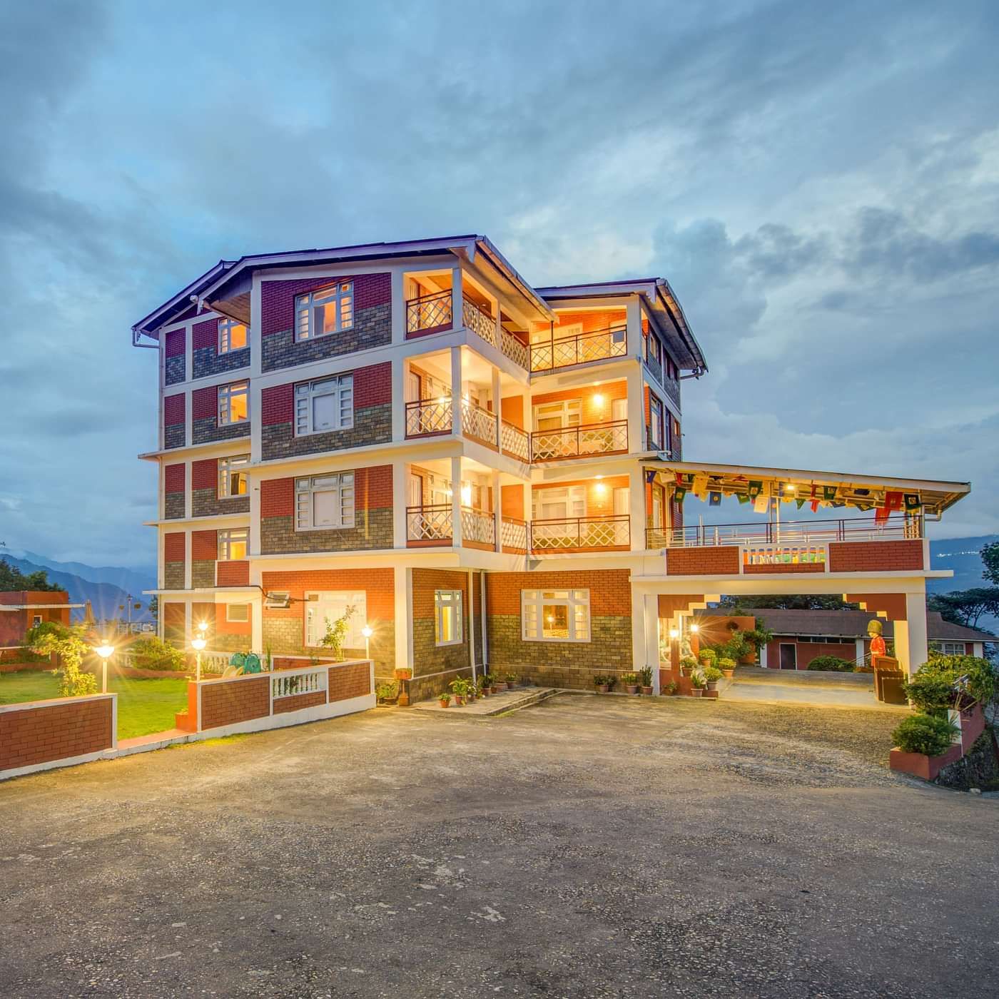 Facade of Summit Tashi Ghang Heritage Resort, Pelling with mountains in the background
