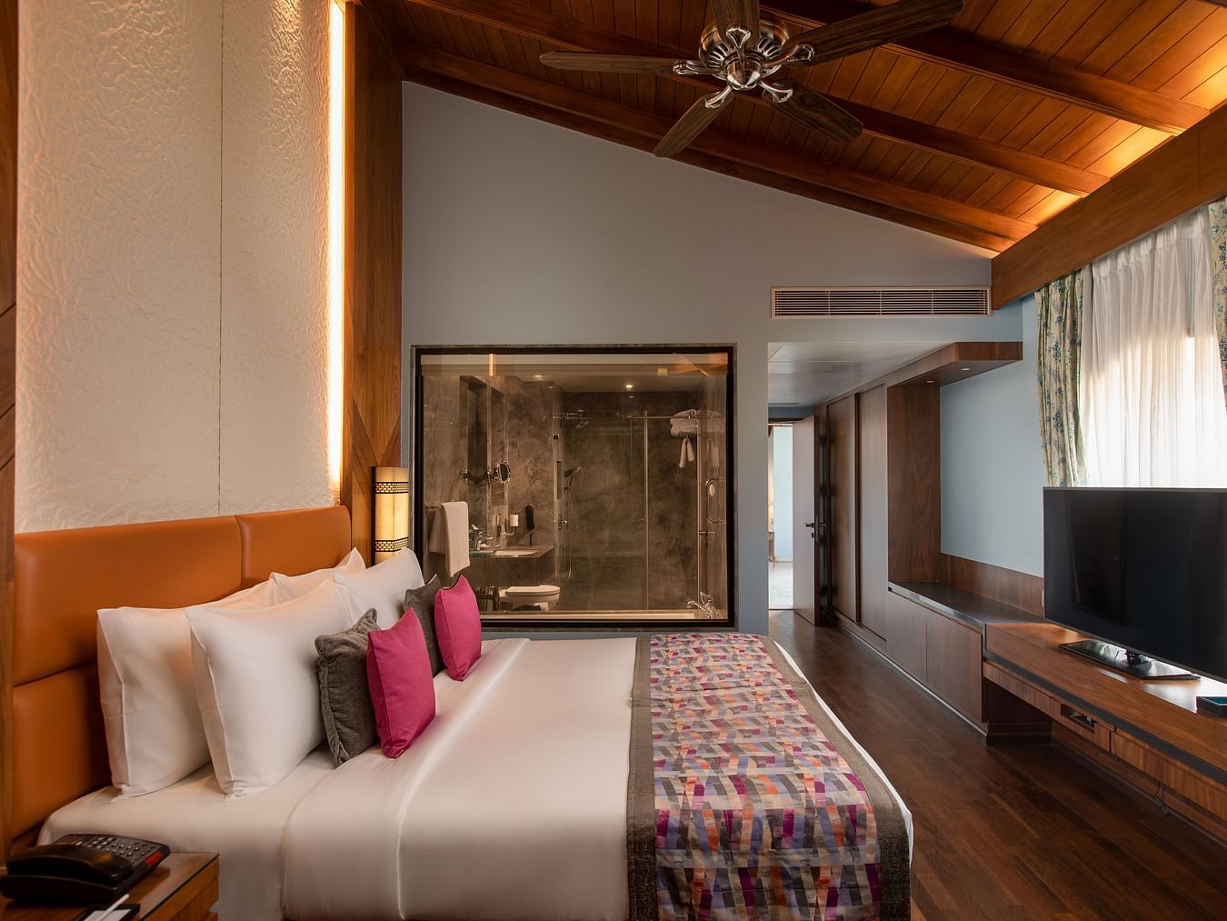 A lovely view of the Presidential Suite King Bed with slanting roof on top with soft lighting