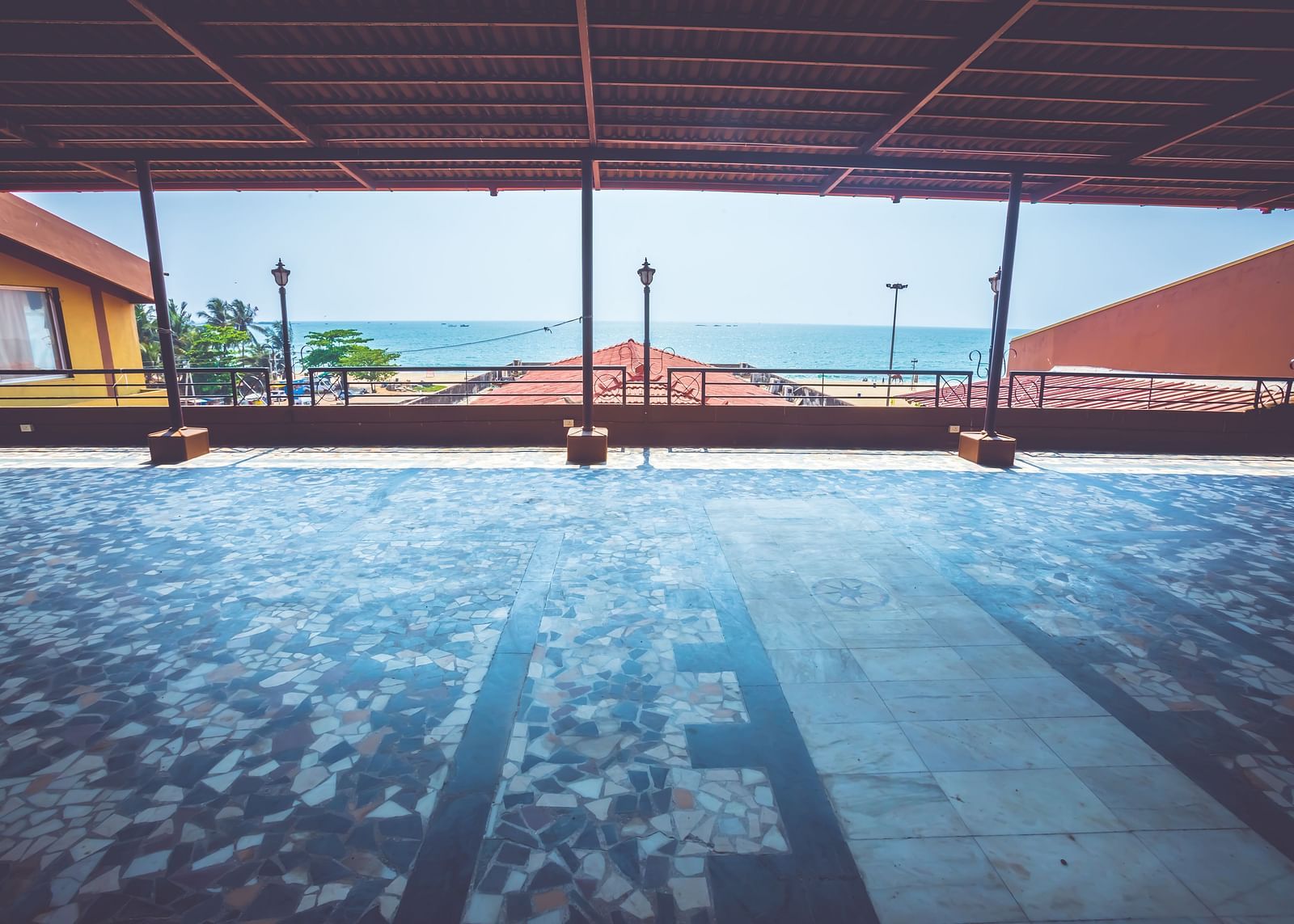 A view of an outdoor event space with sea views at Paradise Isle Beach Resort, Udupi covered using terracotta tiles