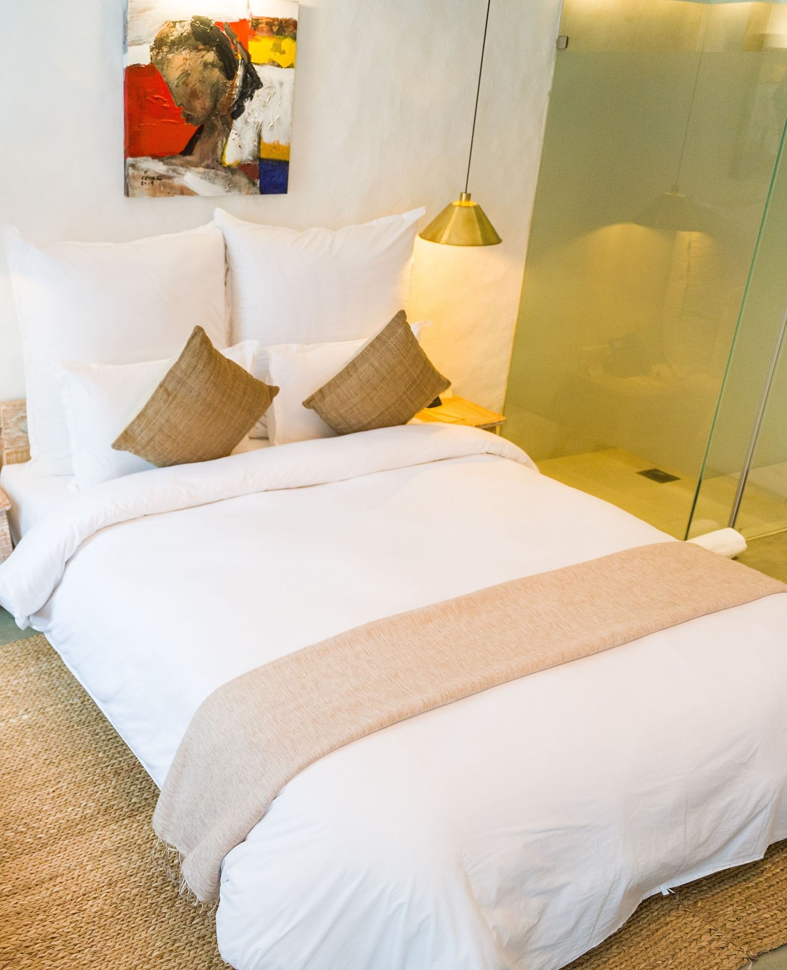 Deluxe loft room with a double bed, and a single bed side tables, and lamps hanging from the ceiling - The Nanee