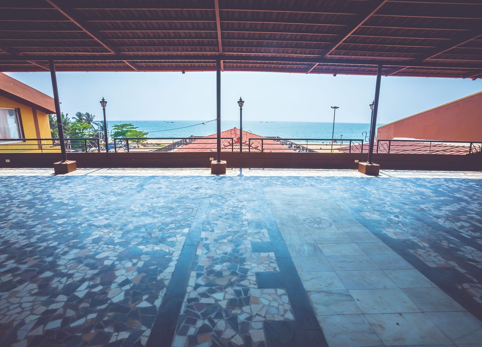 A view of an outdoor event space with sea views at Paradise Isle Beach Resort, Udupi covered using terracotta tiles