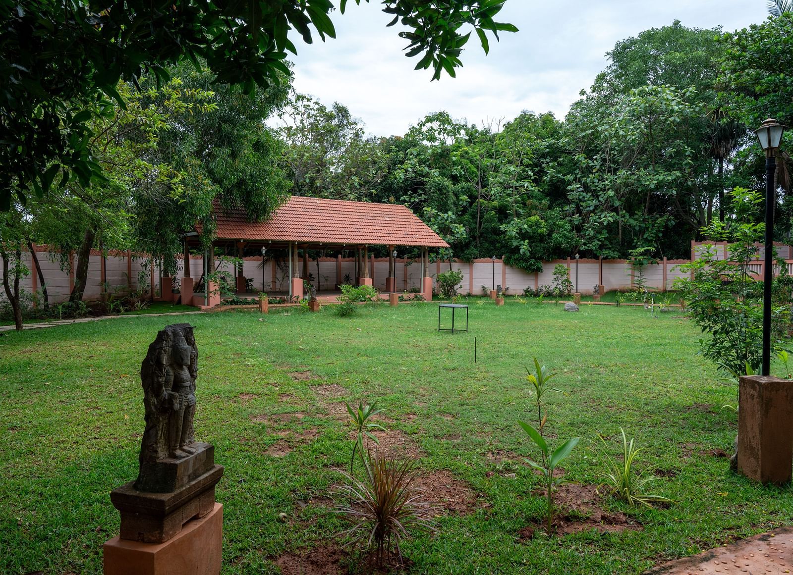 A large patch of land covered by grass and trees with a resting area