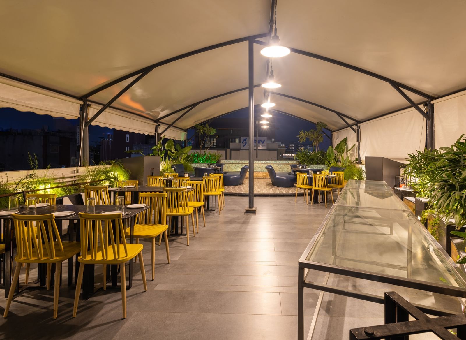 Rooftop dining setup in the Pravasa Cafe at Pravasa Stay Vijay Nagar, Indore.