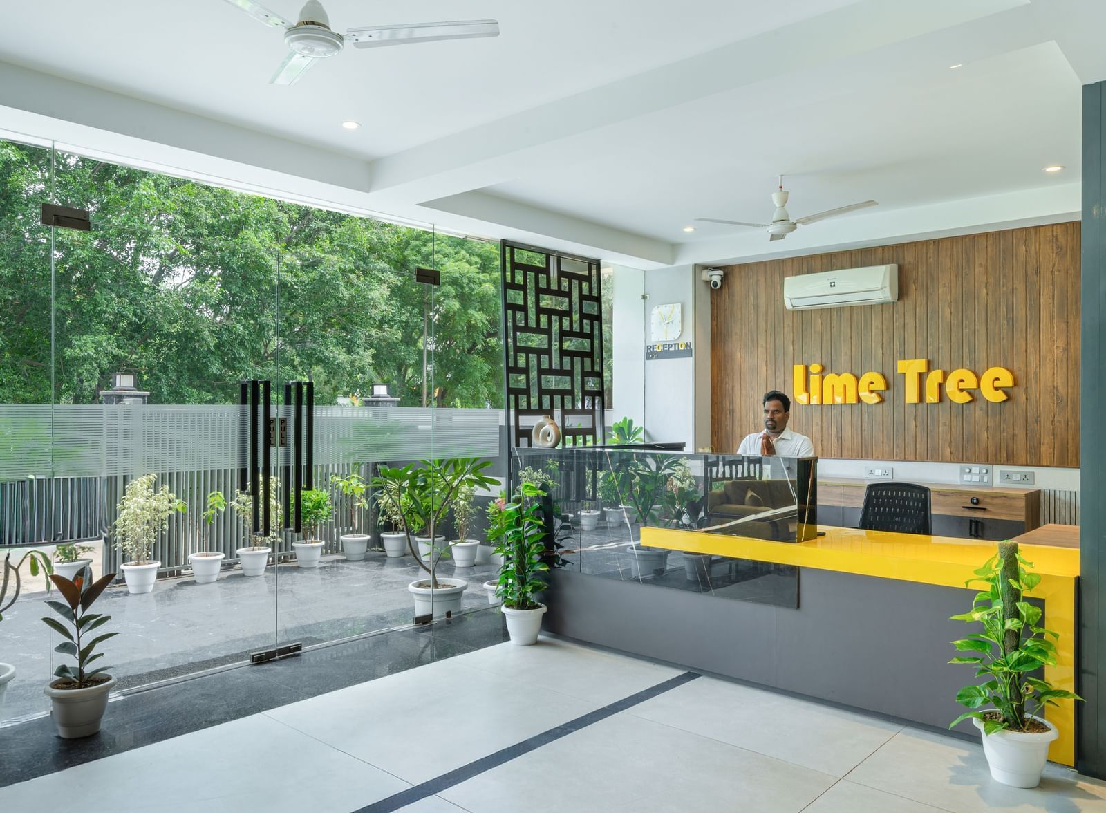 Hotel entrance with plants and stylish front view at Lime Tree Hotel & Stays Greater Noida Nearby India Expo Centre & Mart.