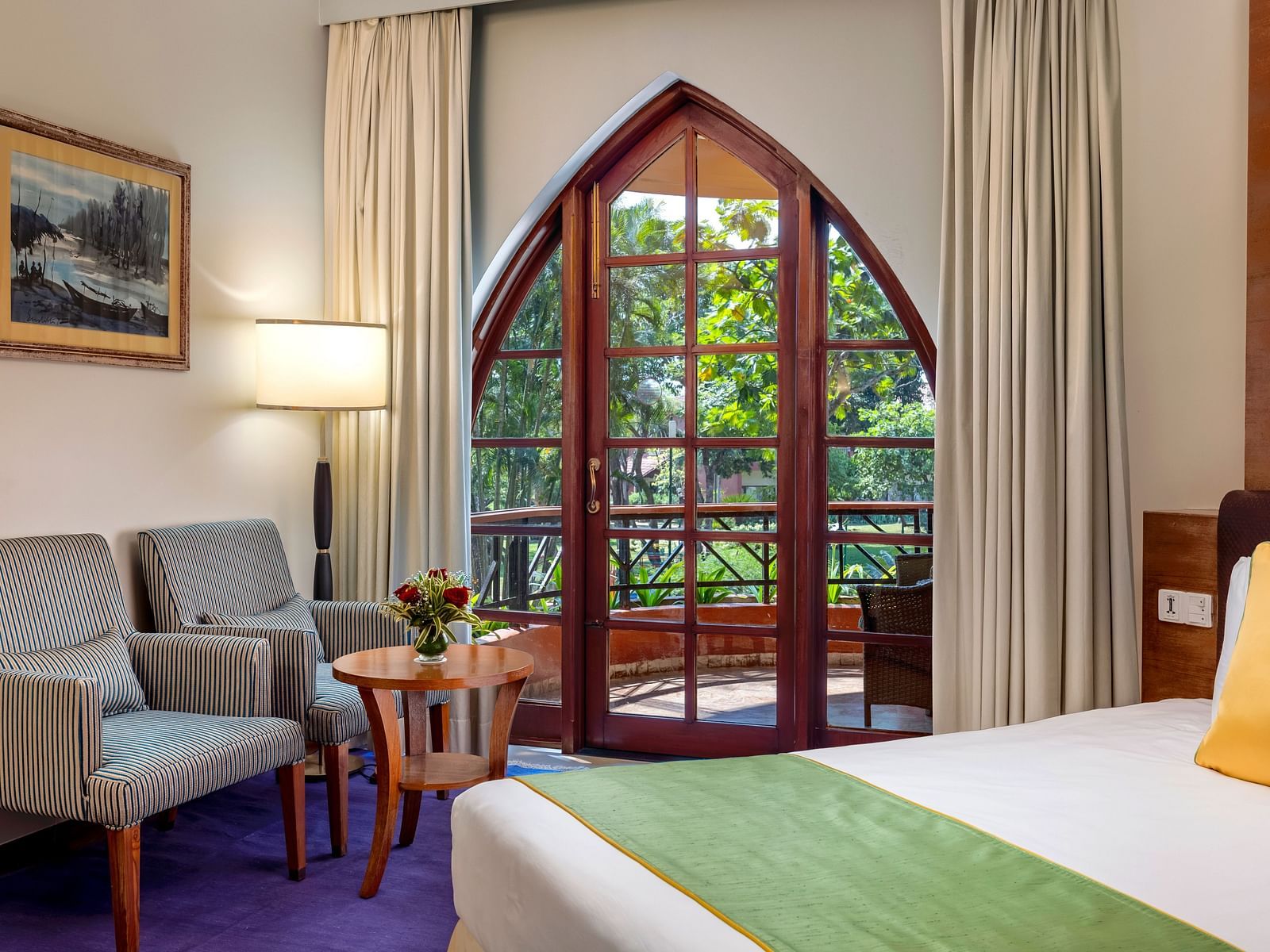 a double bed, sofas and a small table inside Superior Room - Caravela Beach Resort Goa