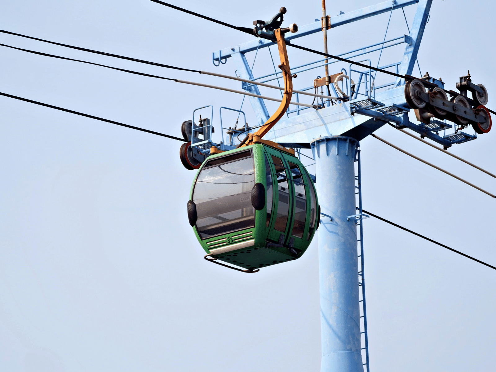 Cable car suspended in the sky on a clear day.