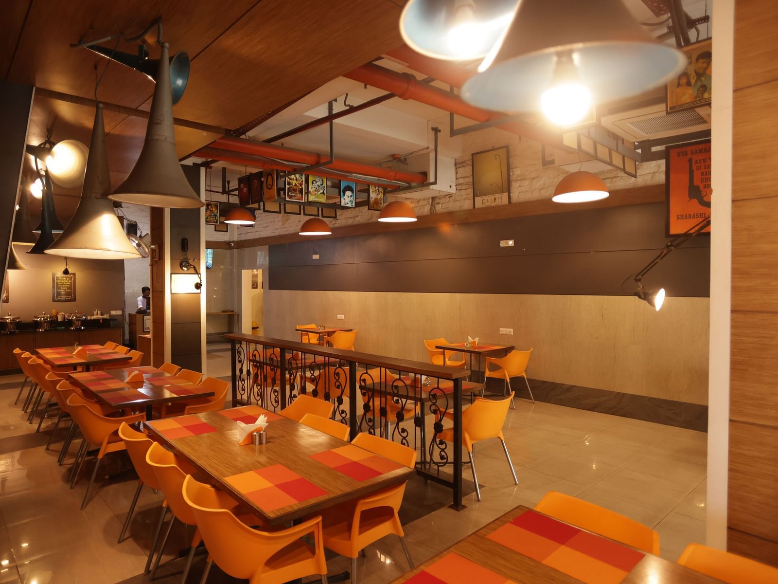 The interior of the Mumbai Masala restaurant at Max Hotel Prayagraj, featuring tables and chairs set for dining.