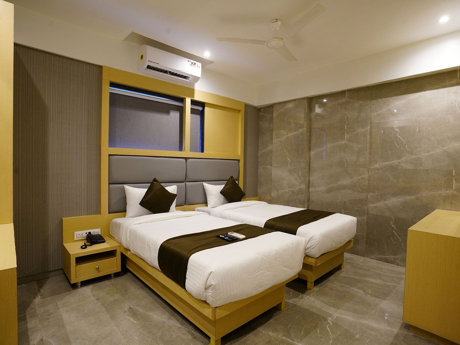 Hotel room with two single beds, bedside tables, and wall shelves - Shyanu Lords Eco Inn Airoli