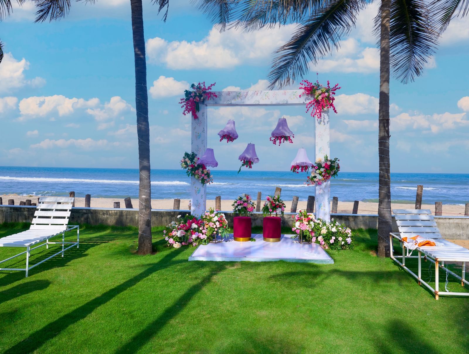 Decorated outdoor space under a blue sky with the sea visible at the backdrop at Grande Bay Resort & Spa.