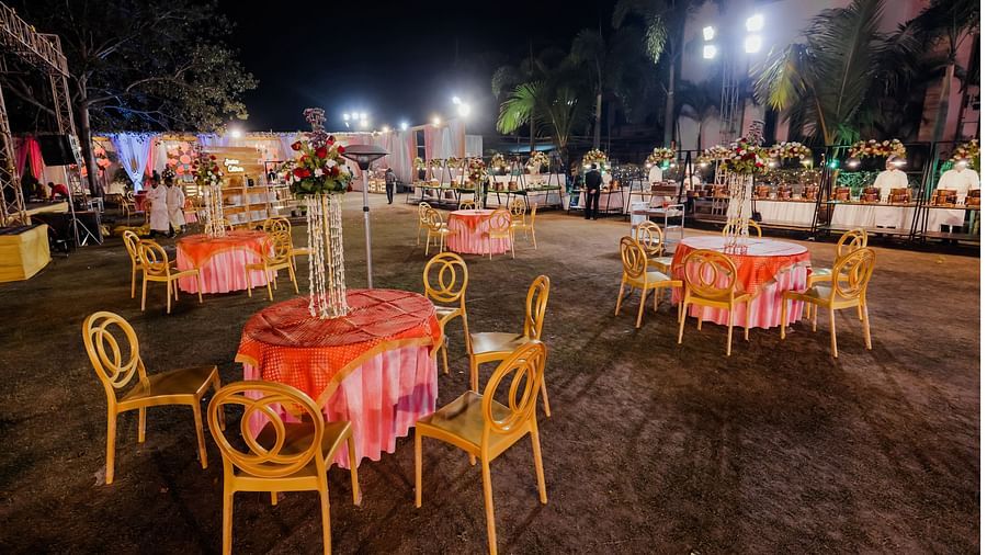 The table-chair arrangements in the outdoor venue - Wedlock Greens Hotel Resorts Dhanbad