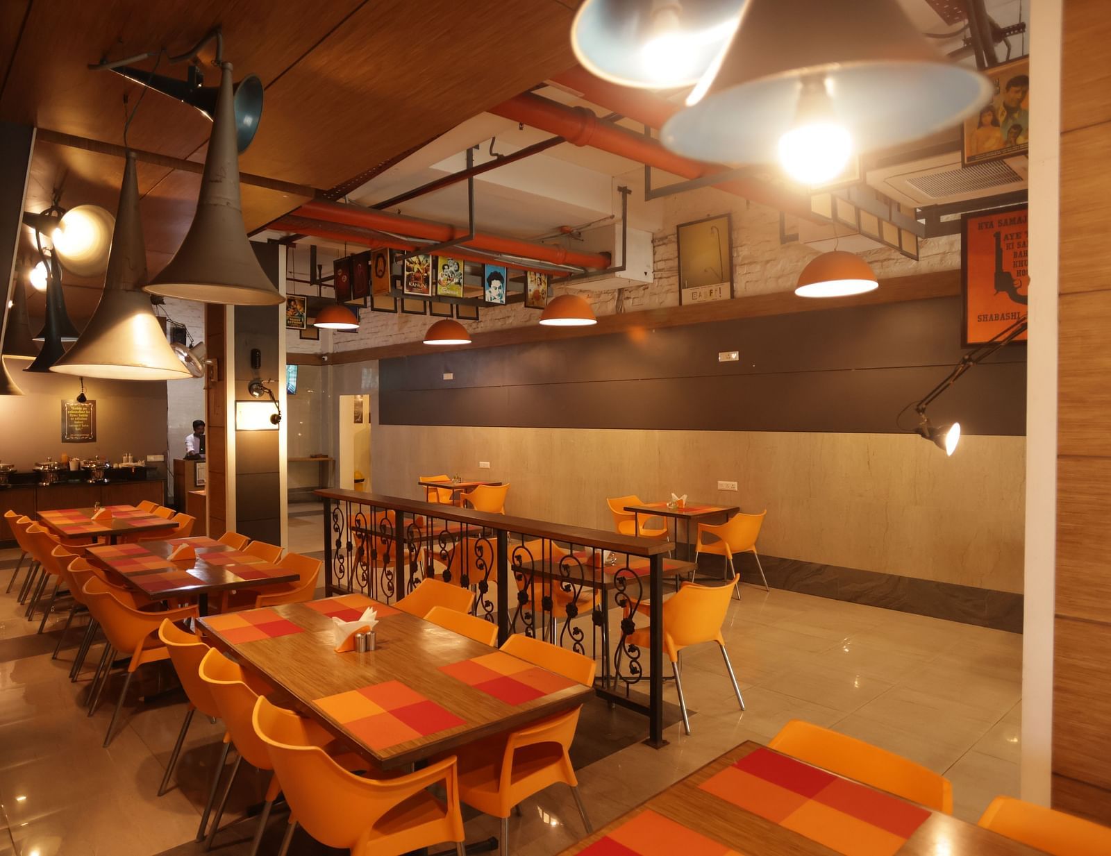 full view image of the dining area with cosy interiors and warm lighting - Max Hotel, Jabalpur