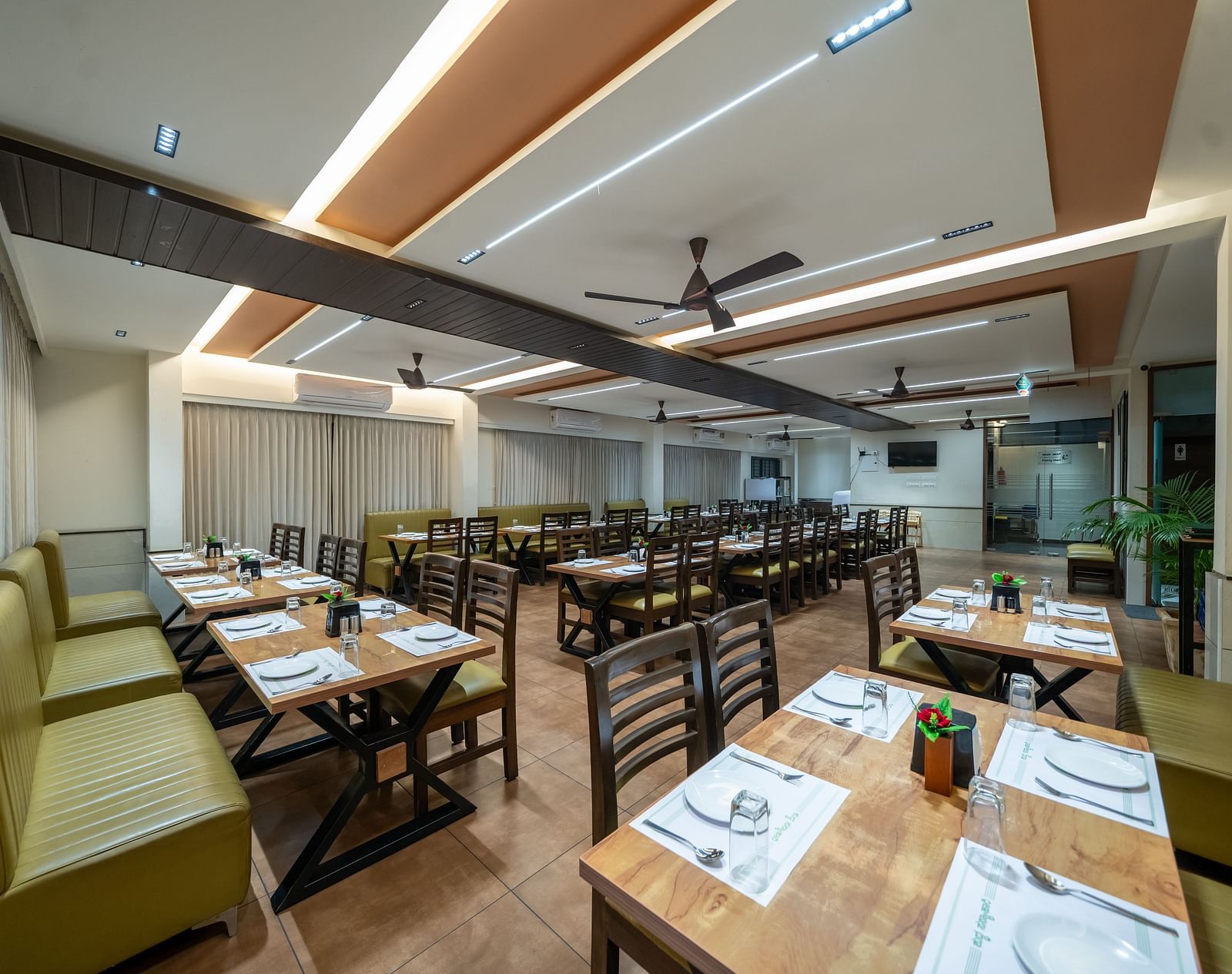 Dining area with close-up view of the neatly set table and chairs kept on both sides of the table at Hari Govinda's