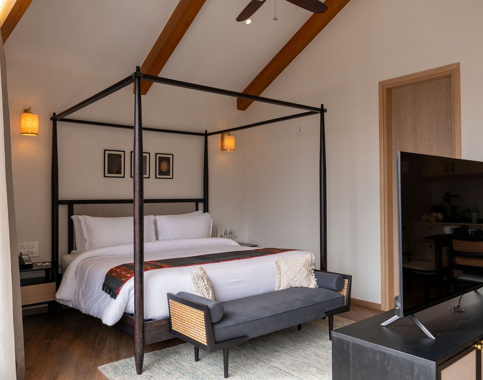 Warm-toned bedroom with wooden beams and plush bedding at Nivasana Manali.