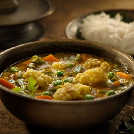 Bowl of Vegetable Kurma with cauliflower and carrots.