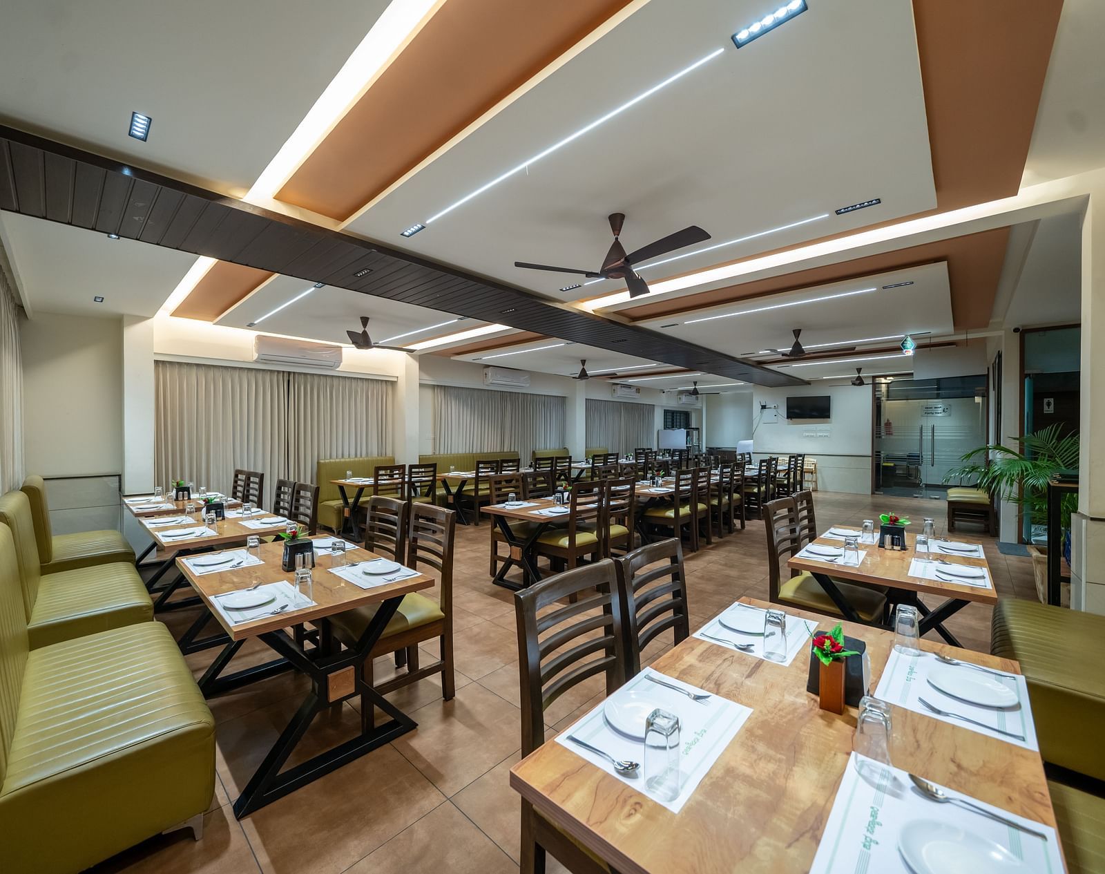 Dining area with close-up view of the neatly set table and chairs kept on both sides of the table at Hari Govinda's