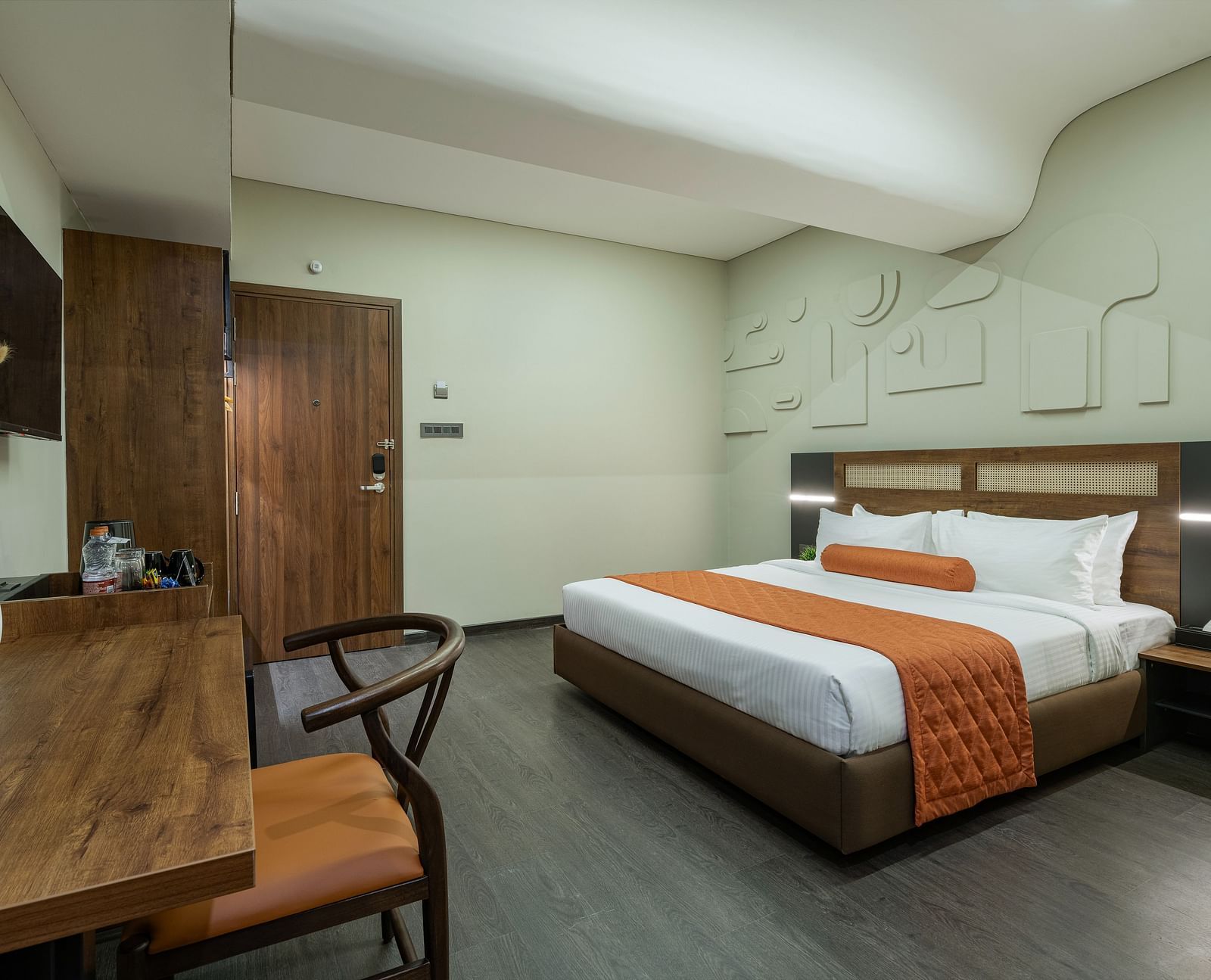 Comfortable Tangerine Room with an in-room safe, a study table and chair alongwith plush beds making a promising stay.
