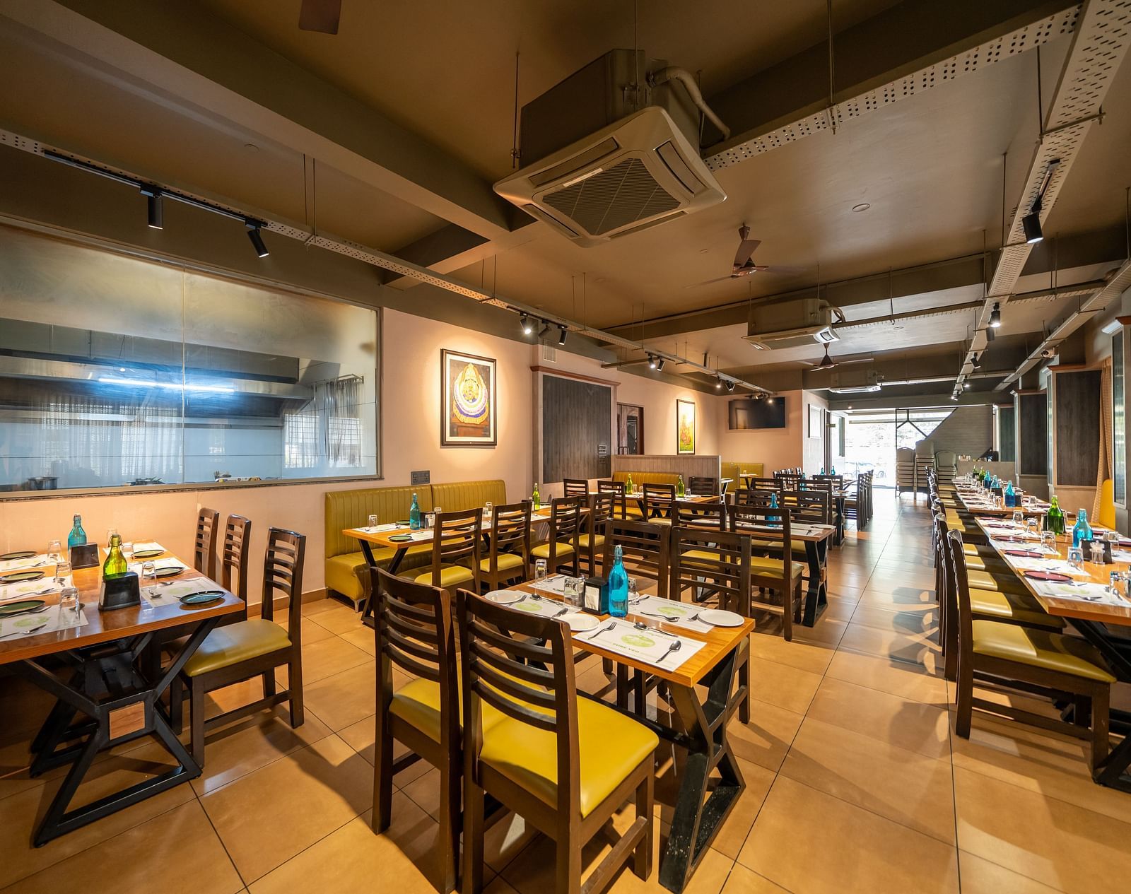 Image of a dining area with tables and chairs arranged around it at Hari Govindas, Siddappa Square.