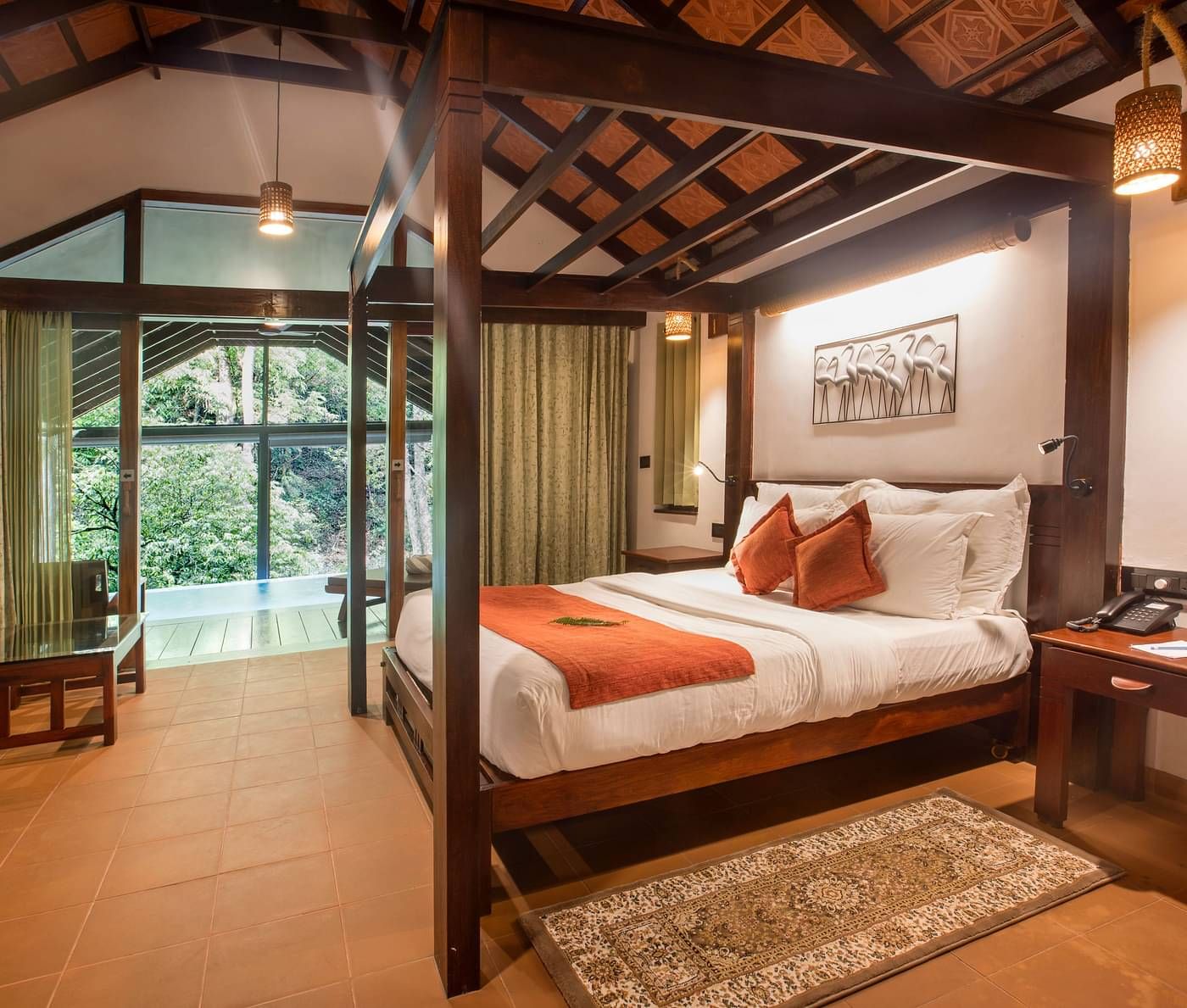 Room with a double bed, wooden accents, and forest views at Vythiri Resort, Wayanad