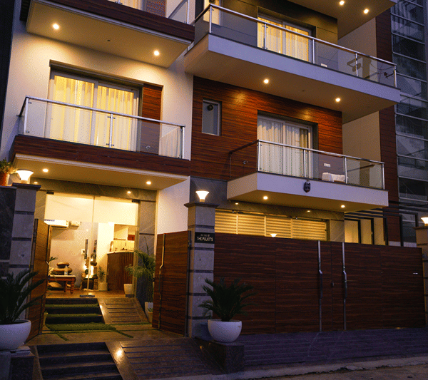 Illuminated facade of Lime Tree Hotel, Pulkit at dusk.