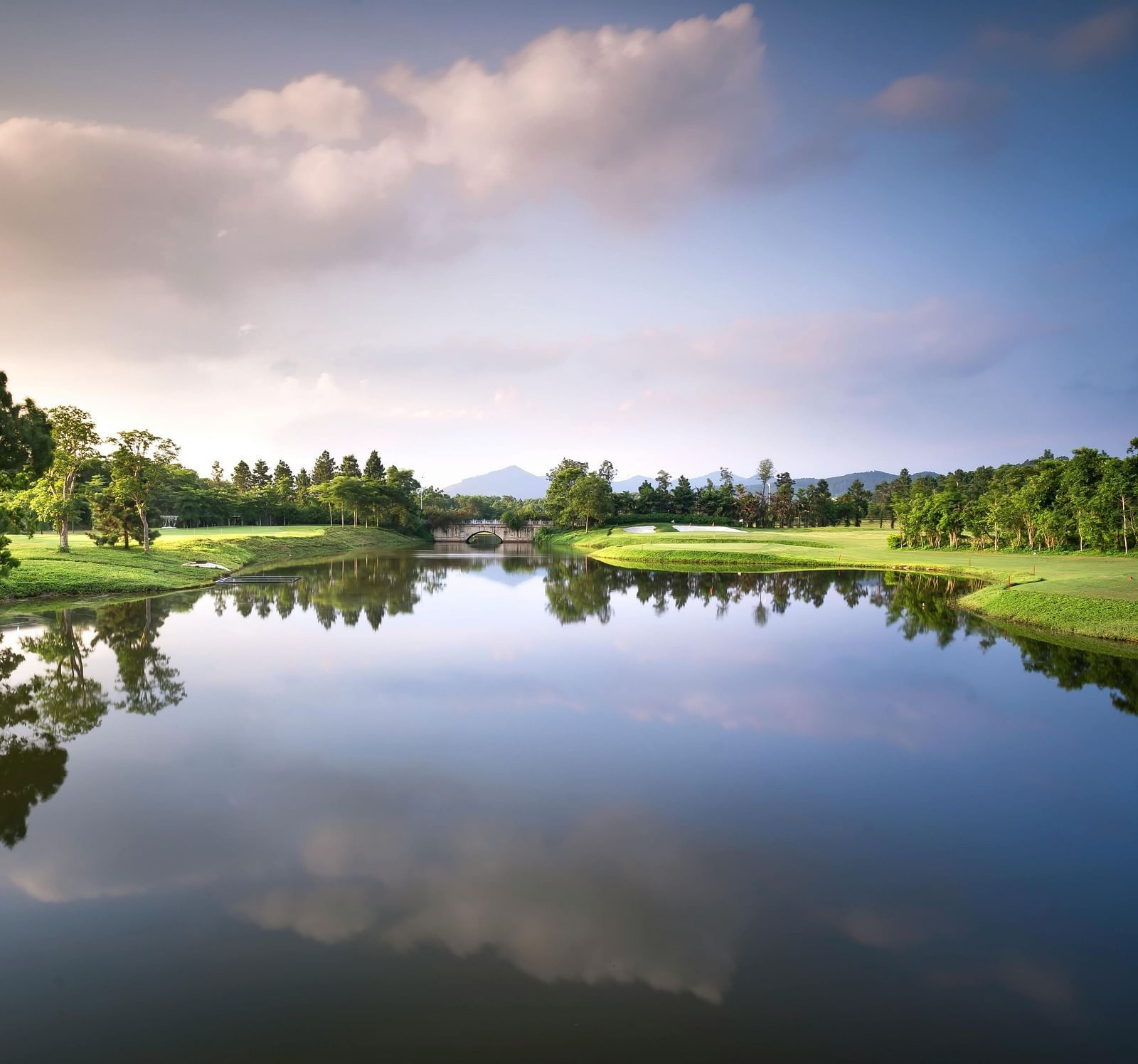 a serene landscape of a lake with lush green landscapes around it in shillong