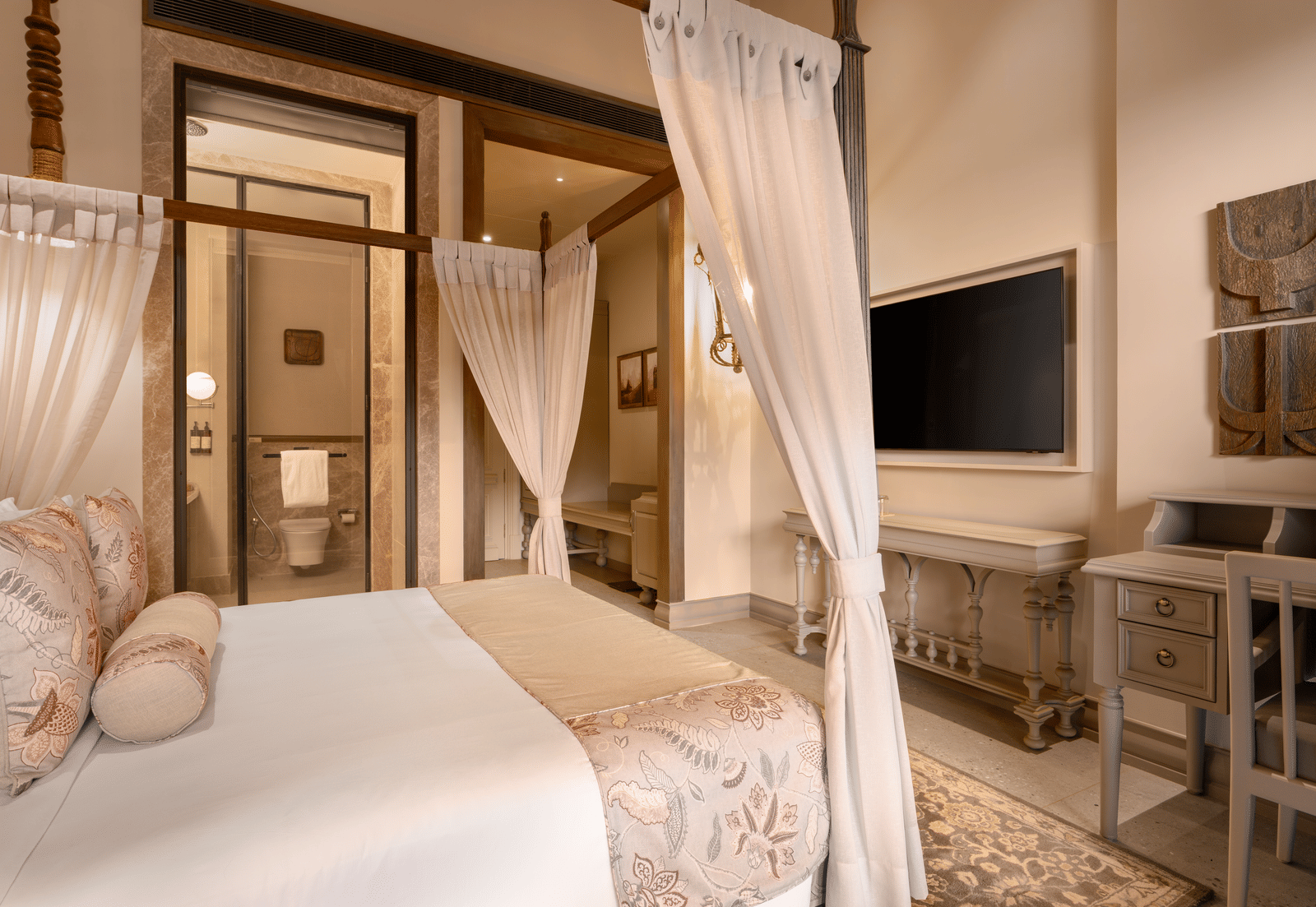 Corner view of the Premium Room featuring a double bed along with a wall mounted television in front of it at The Evren, Vagator.