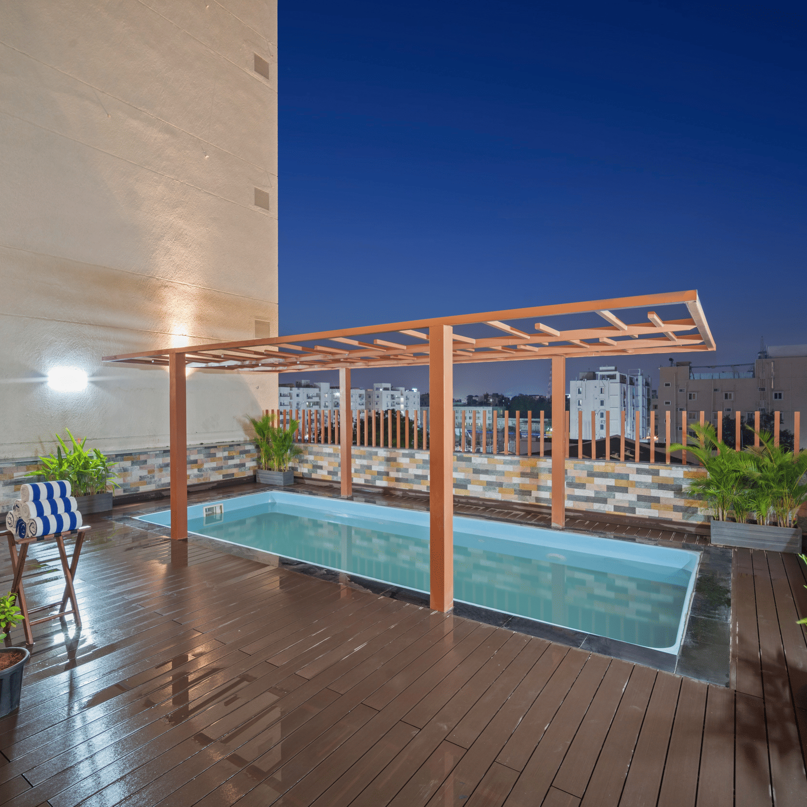 An image of a swimming pool at night of Grand Vijayawada by GRT Hotels.