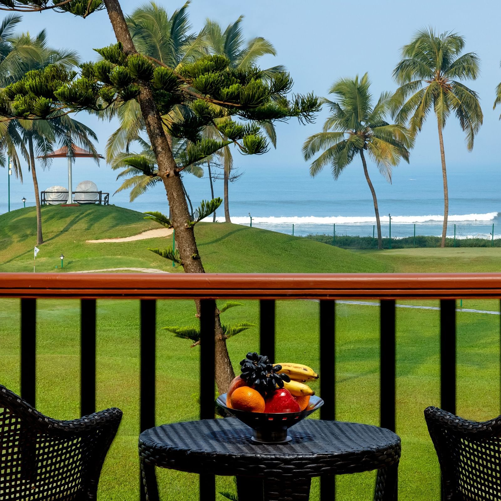 two chairs and a table in the balcony of Ocean front view - Caravela Beach Resort Goa