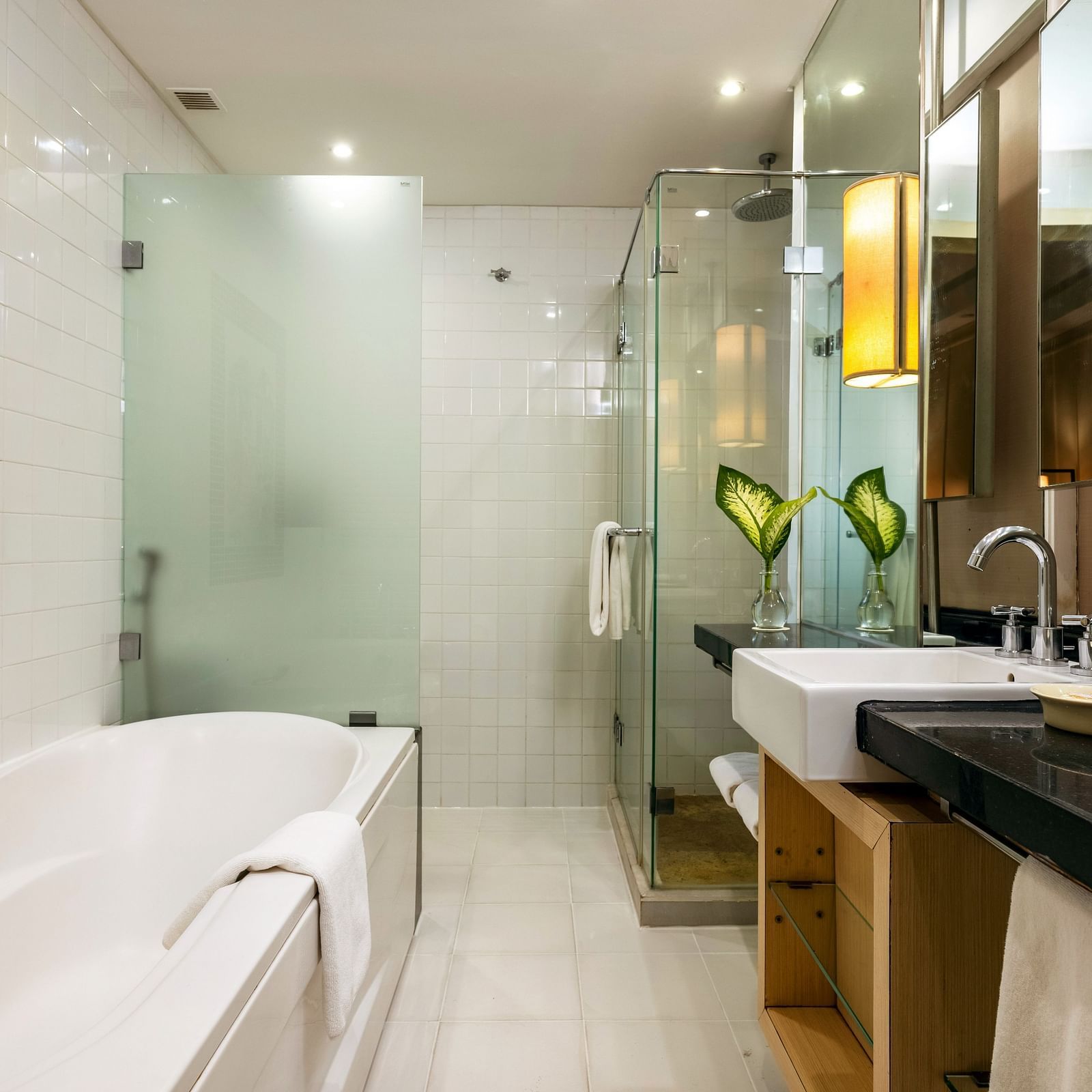 overview of the bathroom with the bathtub in view inside one of the rooms - Caravela Beach Resort Goa