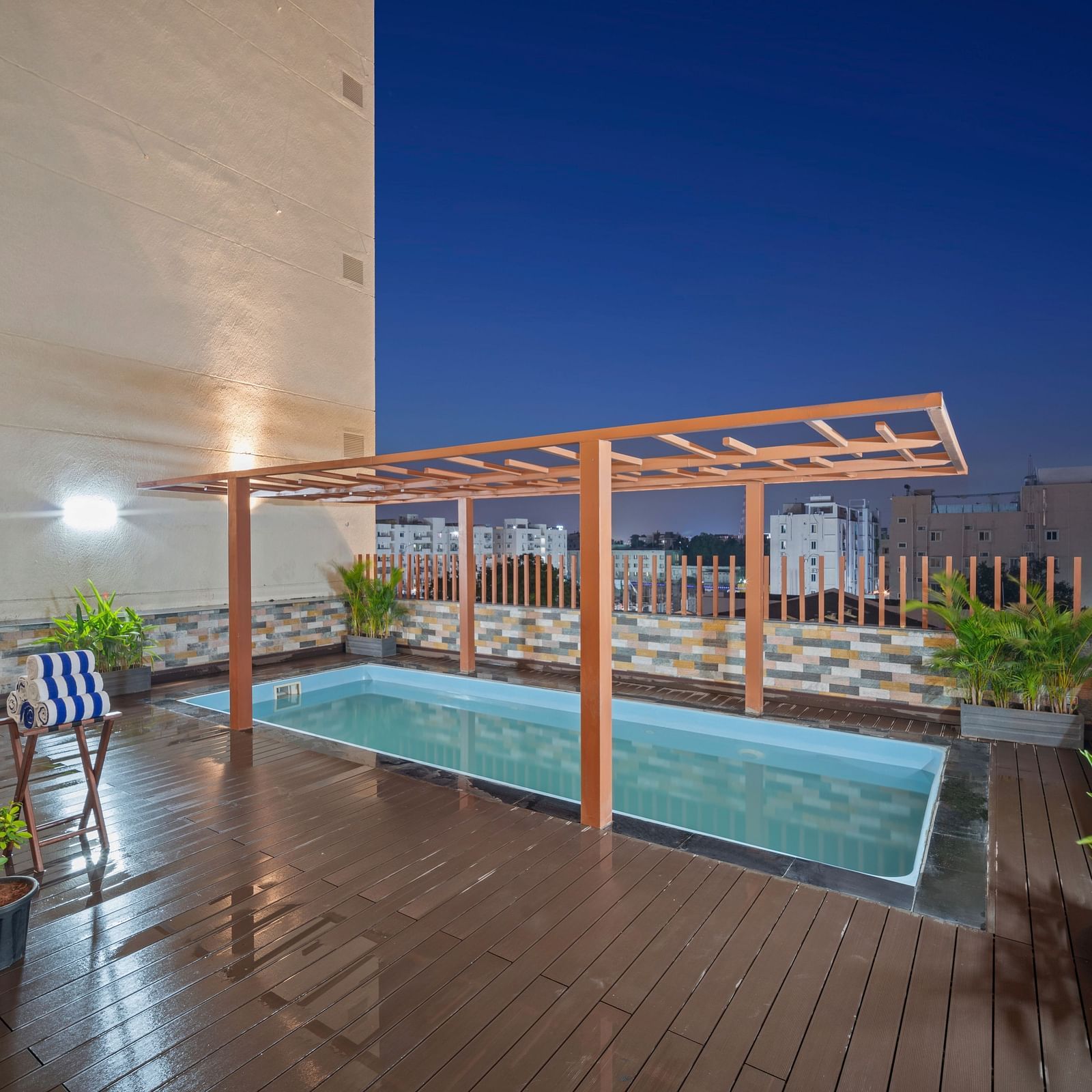 An image of a swimming pool at night of Grand Vijayawada by GRT Hotels.