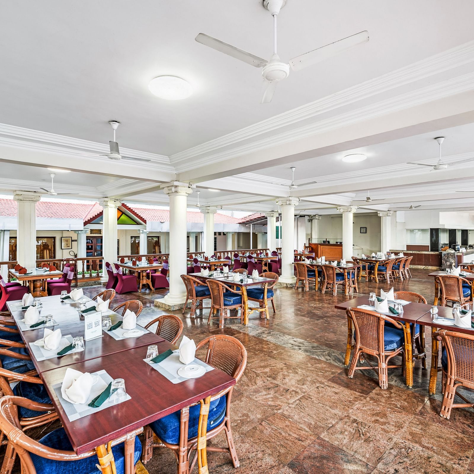 An image of the outdoor dining area featuring tables and chair at GReaT Trails River View Resort Thanjavur By GRT Hotels