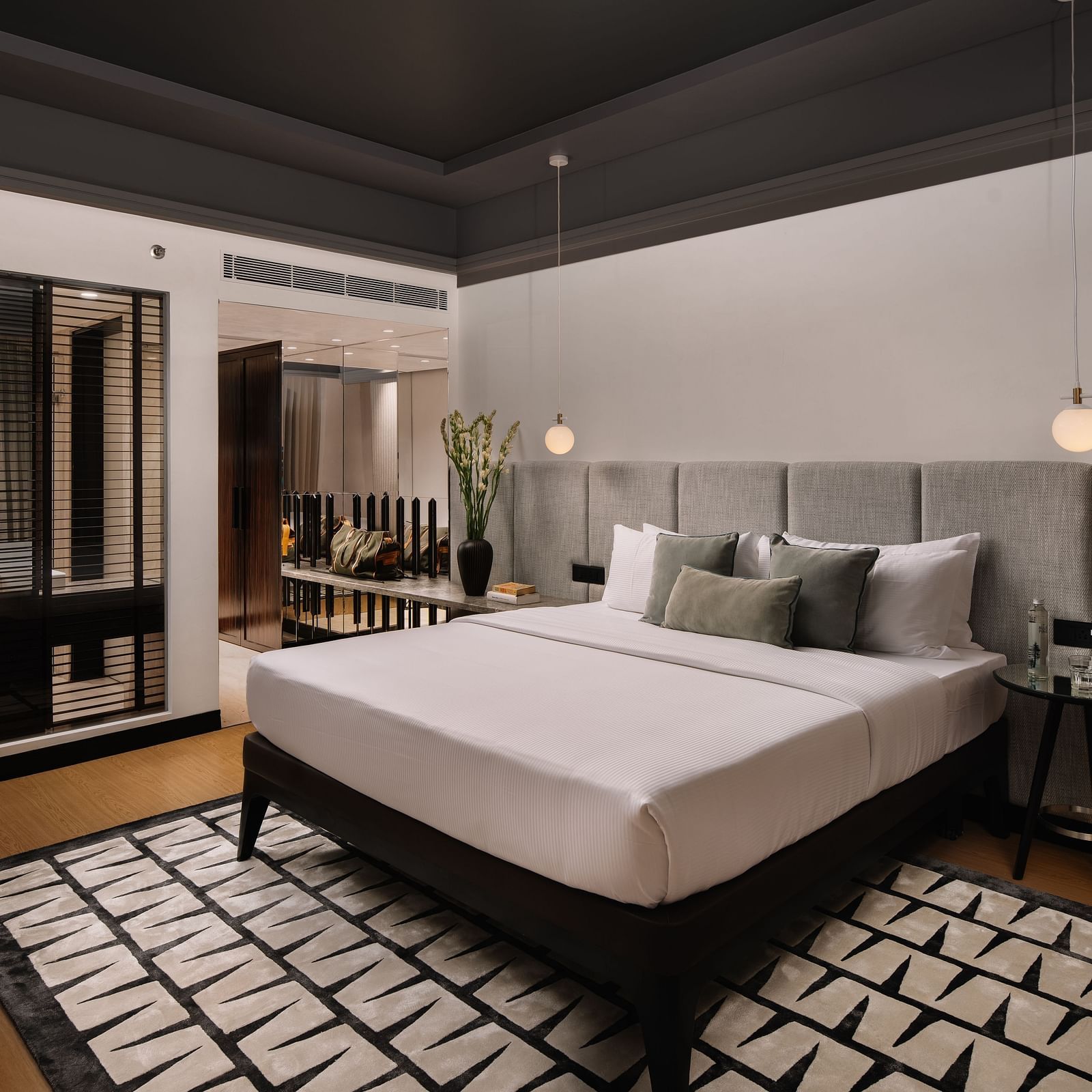 A room with a bed and a carpet below it at The Raintree Hotel, St. Mary's Road.