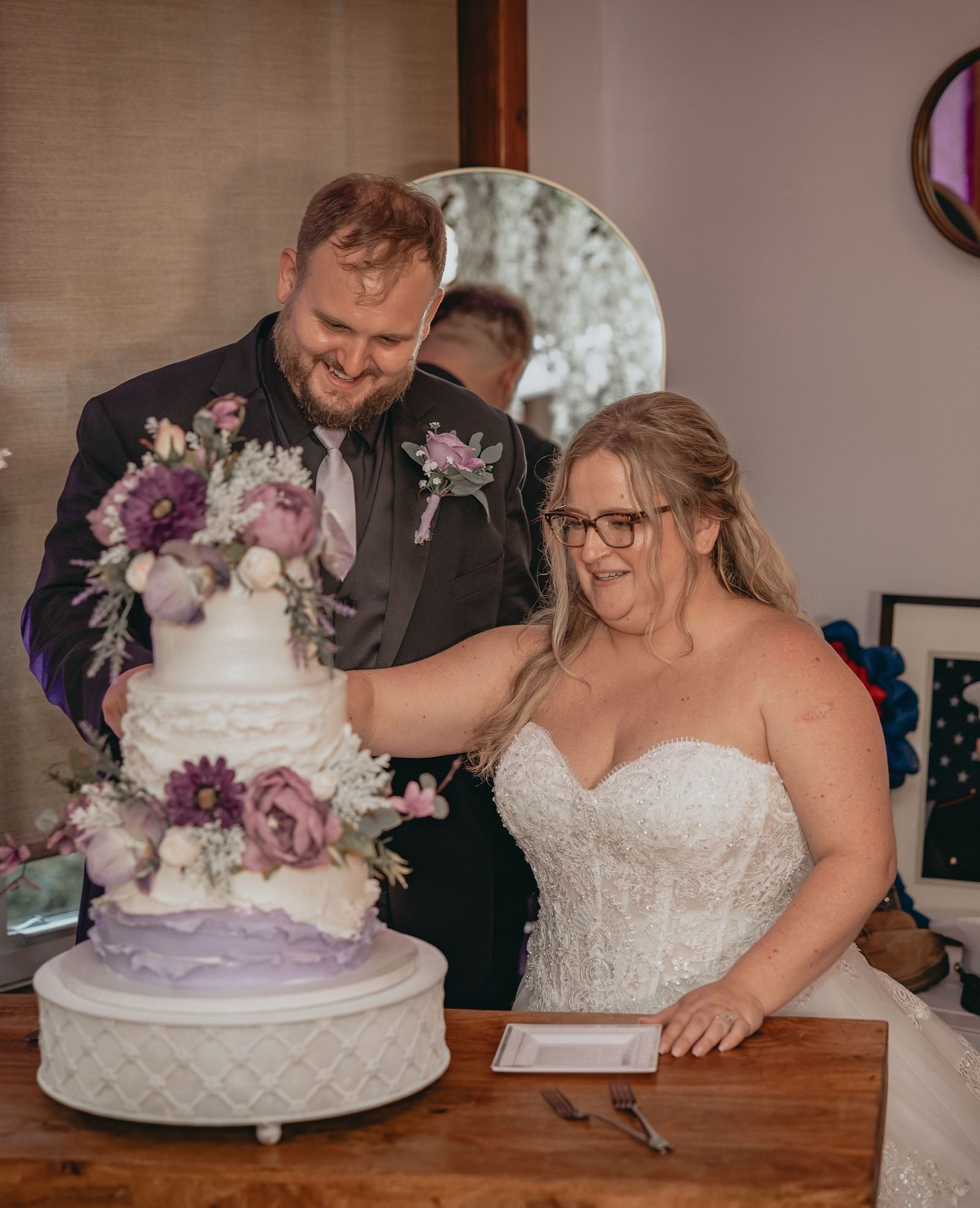 Just married couple cutting the multi layer cake together to celebrate their wedding at the Historic Tapoco Lodge