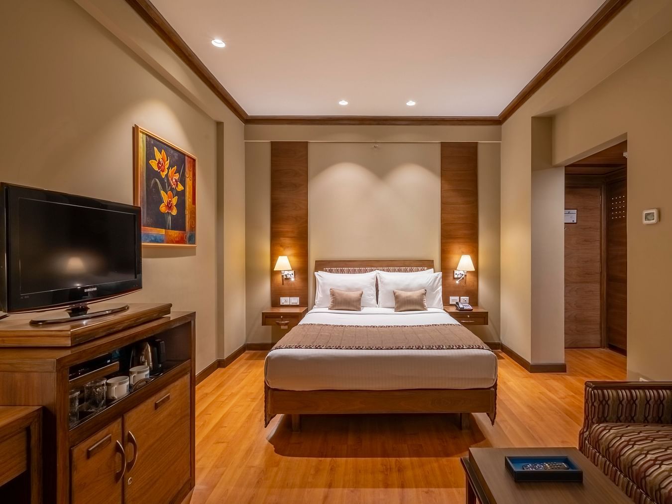 front view of a double bed with beige linen in the Business Club Room at Kenilworth Hotel, Kolkata