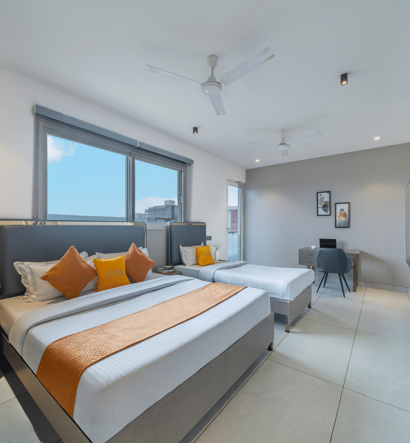 Bright guest room with modern decor and comfortable bedding at Lime Tree Hotel & Stays Greater Noida Nearby India Expo Centre & Mart.