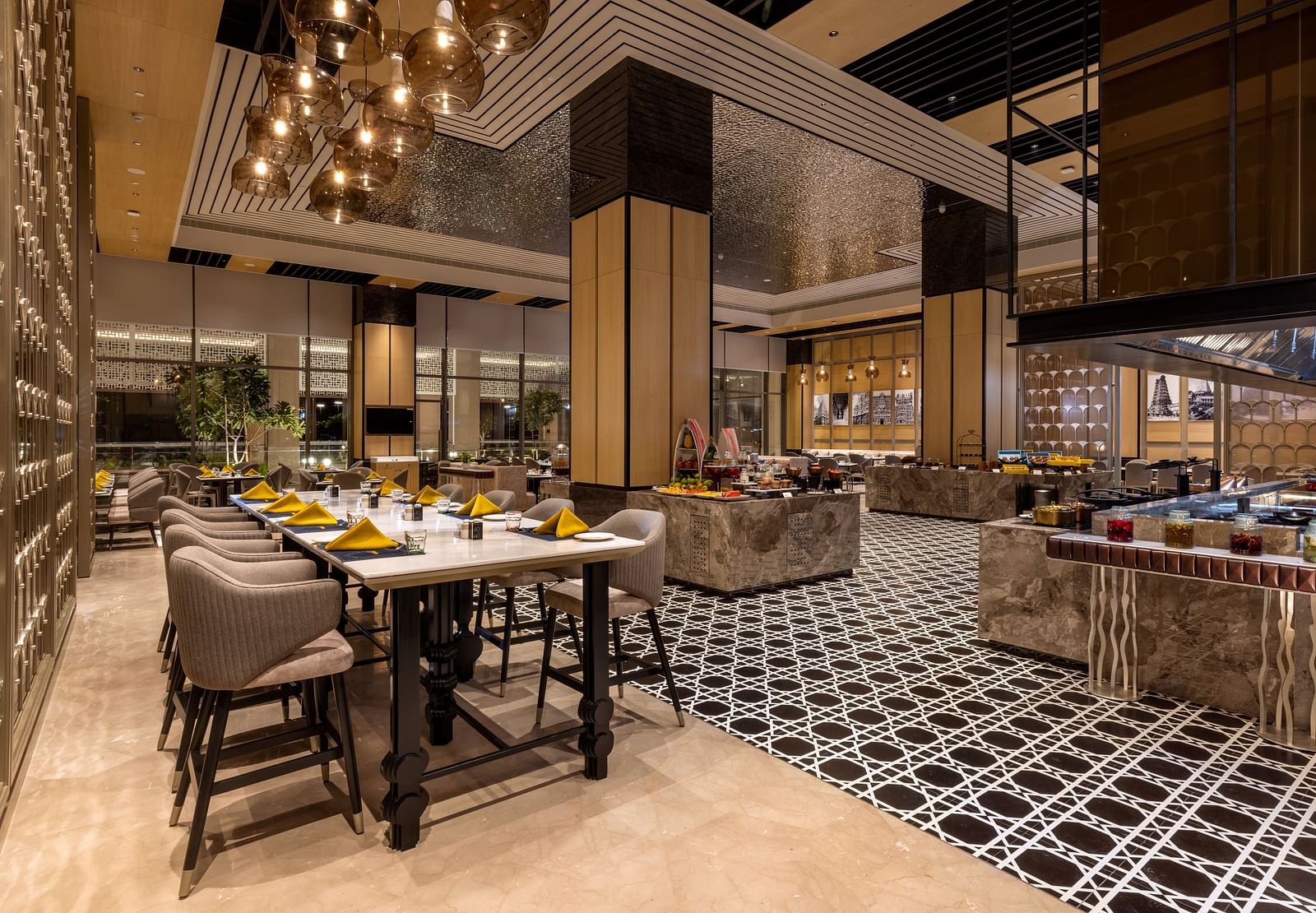 Contemporary dining space with striking geometric flooring and luxurious finishes - Grand Madurai by GRT Hotels