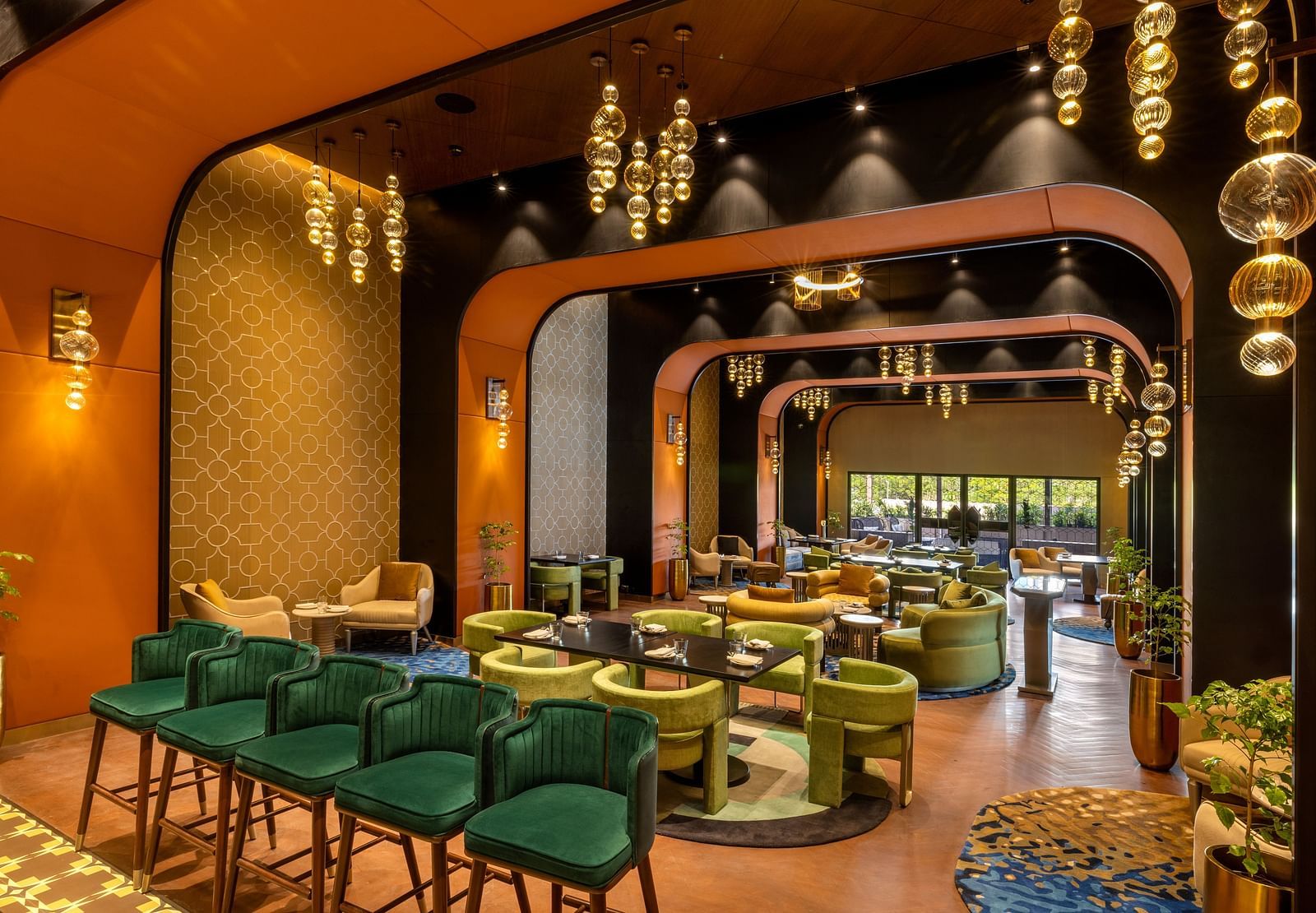 Stylish dining area featuring contemporary design and vibrant green seating - Grand Madurai by GRT Hotels