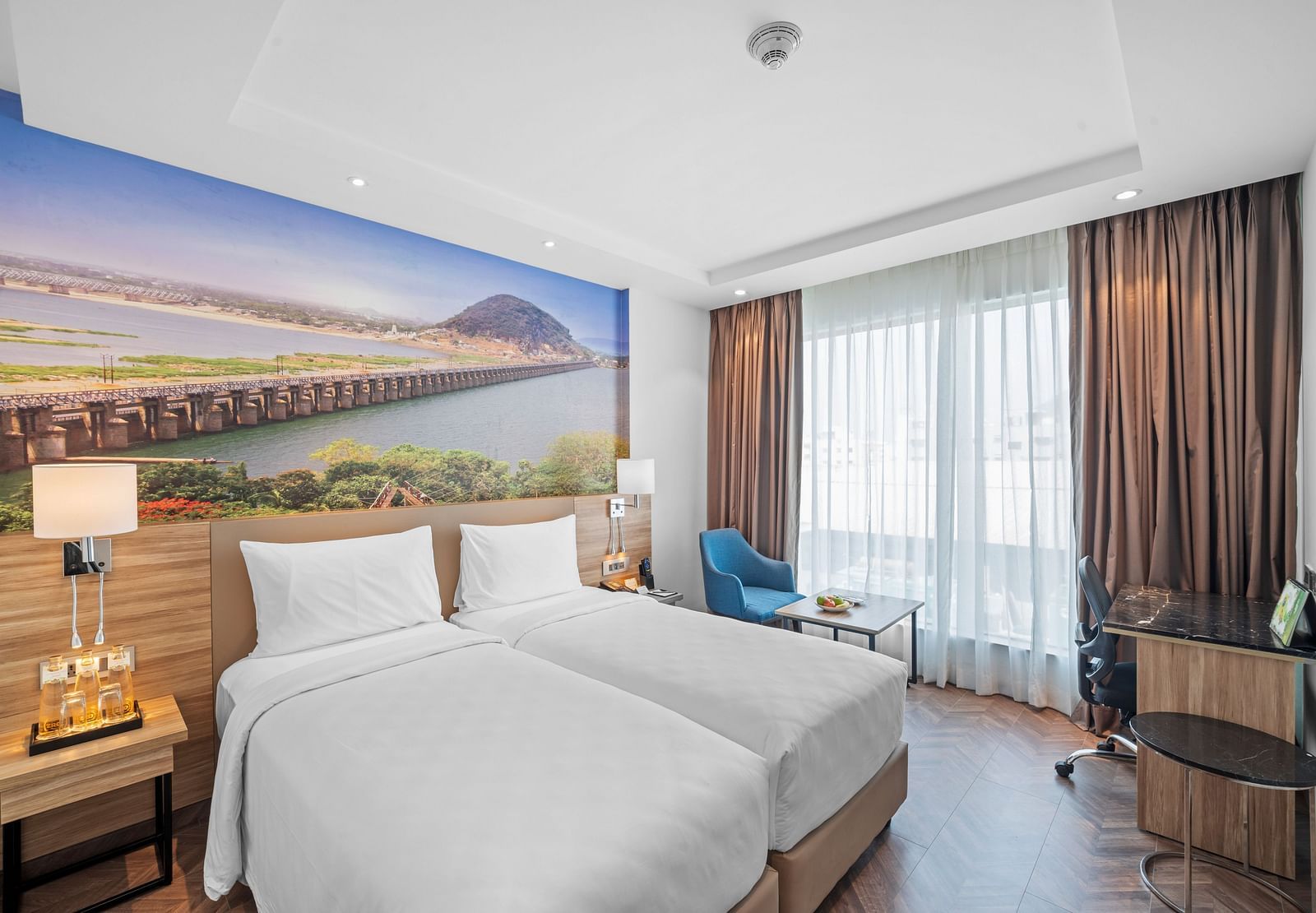 An image of twin beds of a room at Grand Vijayawada by GRT Hotels.