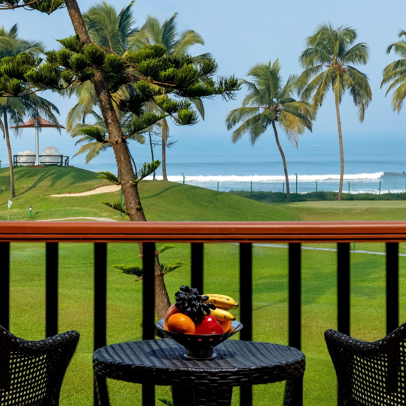 two chairs and a table in the balcony of Ocean front view - Caravela Beach Resort Goa
