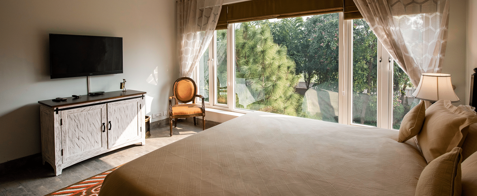  An image of a room with TV, big glass windows at BluSalzz Resort.