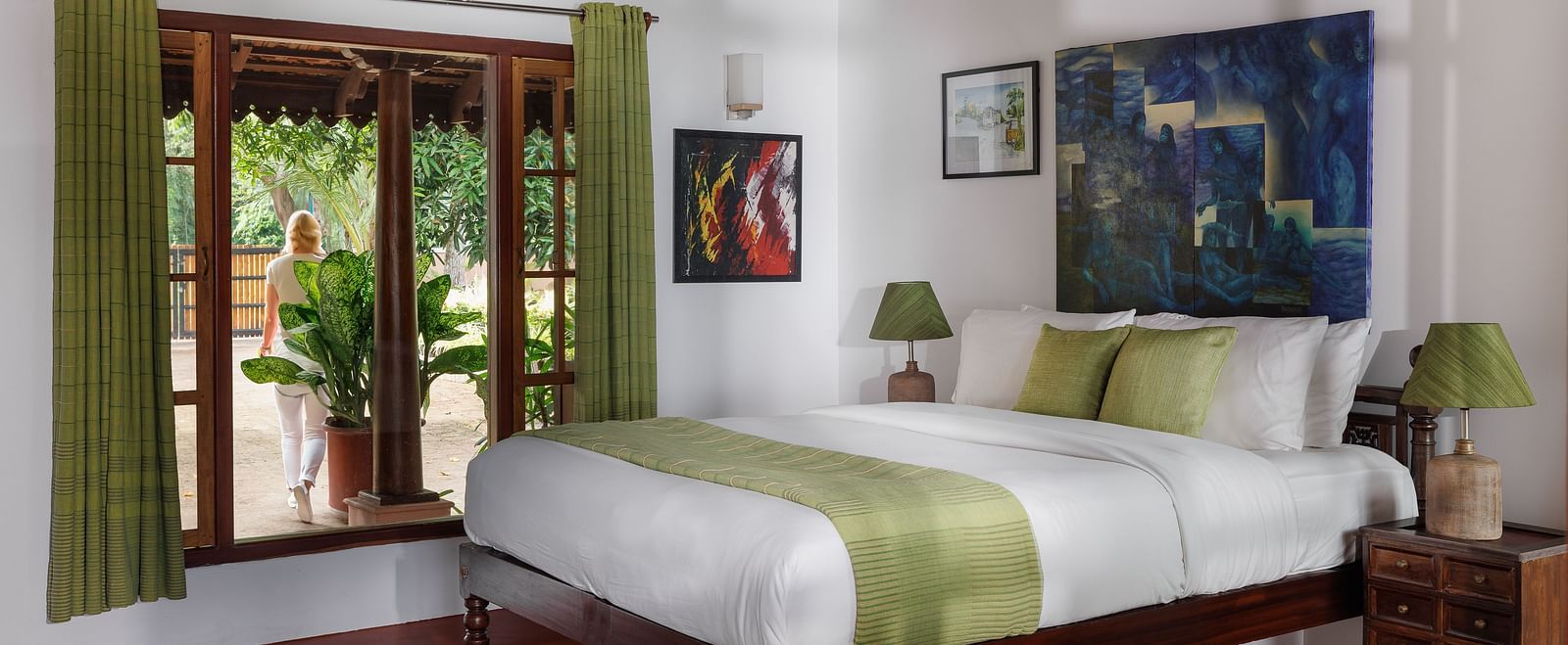 A room with a bed, wooden decorative items, and a glass window overlooking the view - BluSalzz Villas - Muhamma Resort, Alleppey