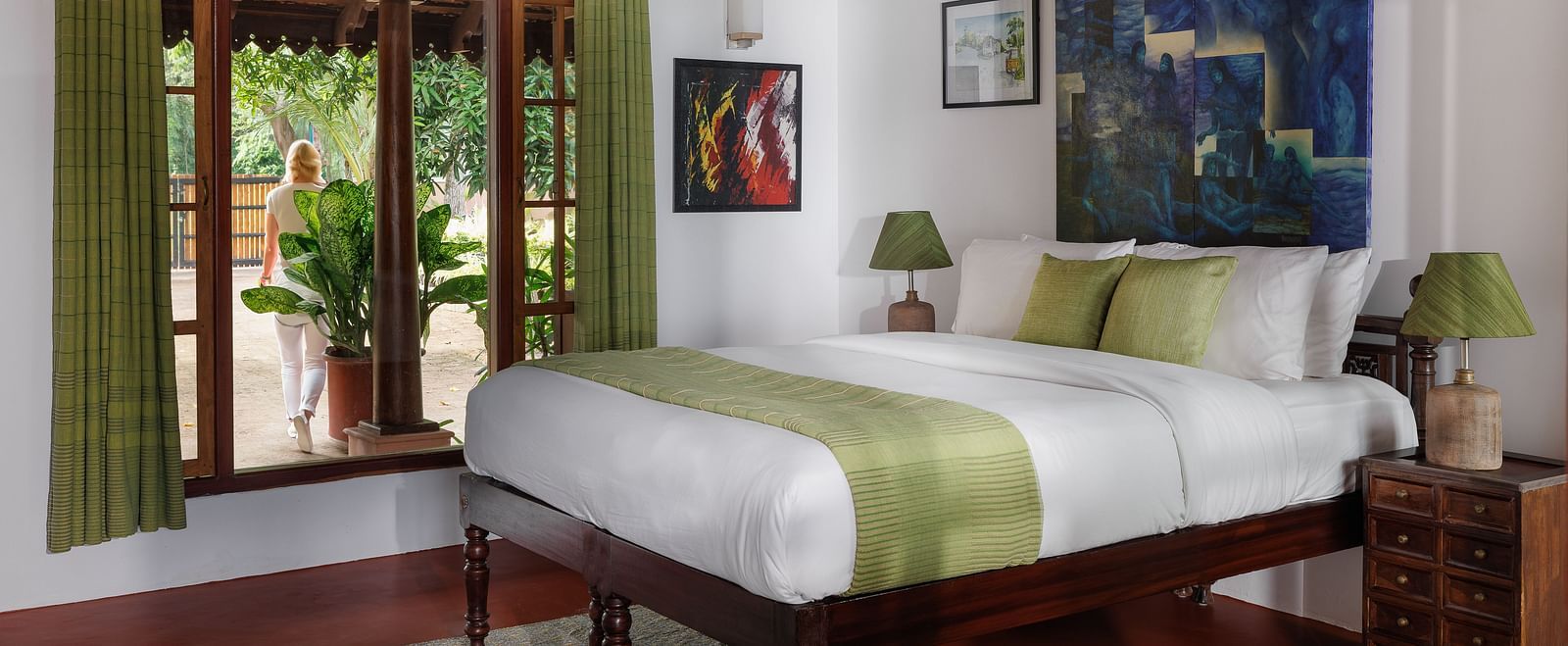 A room with a bed, wooden decorative items, and a glass window overlooking the view - BluSalzz Villas - Muhamma Resort, Alleppey