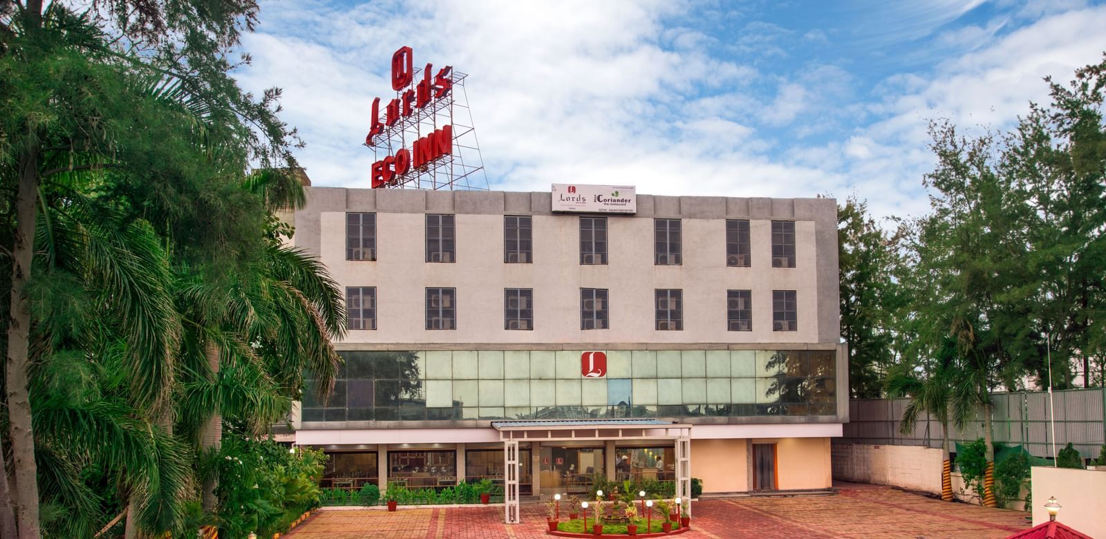 Front facade of Lords Eco Inn Dahej featuring the main driveway and landscaped surroundings.