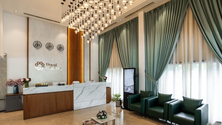 Lobby with modern seating arrangement and elegant curtains at Hotel Royal Regency Chennai