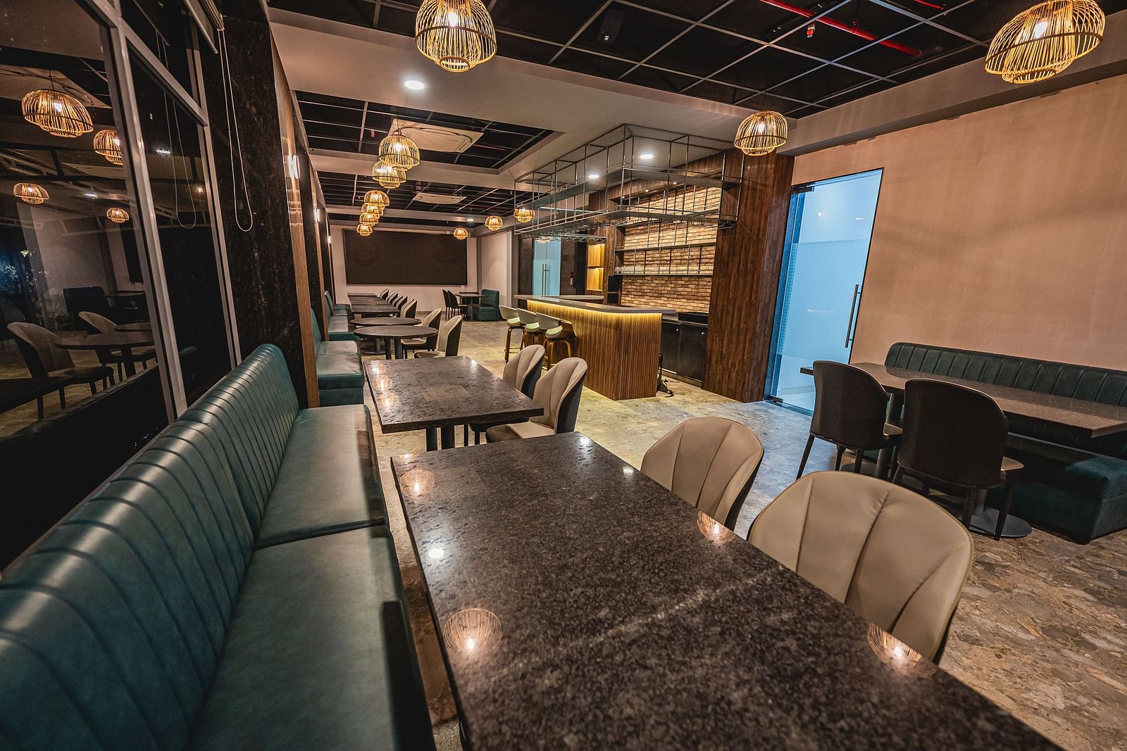 A stylish dining area with elegant booths and ambient lighting at Lotus Leaf Boutique Hotel.