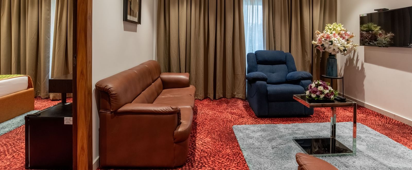 Suite-style room with separate seating and bedroom area at Hotel Royal Regency Chennai