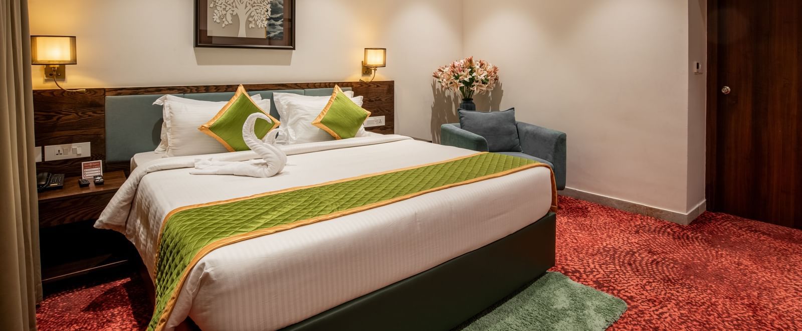 Bedroom featuring king size bed, bedside lamps, and warm lighting at Hotel Royal Regency Chennai