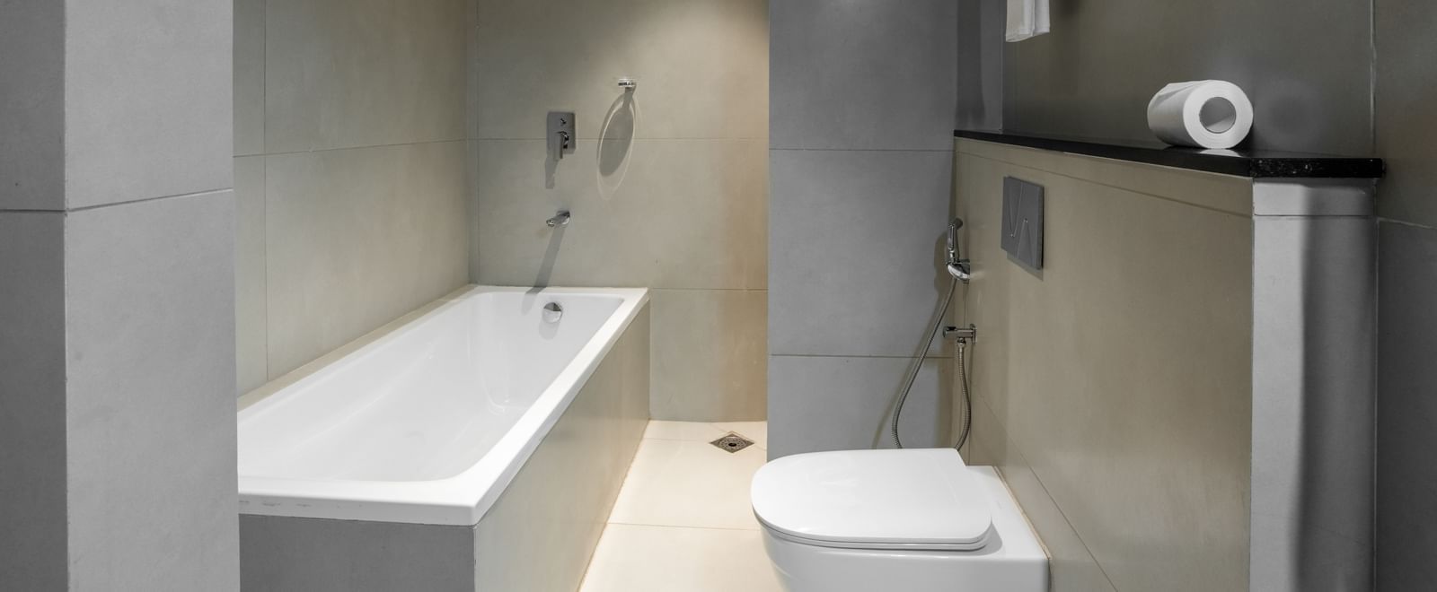 Bathroom with bathtub, shower, and modern fittings at Hotel Royal Regency Chennai