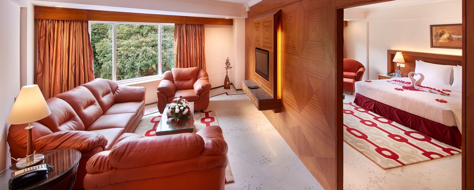 A room at Accord Highland Ooty with a double bed and sofa arrangement in a separate living room